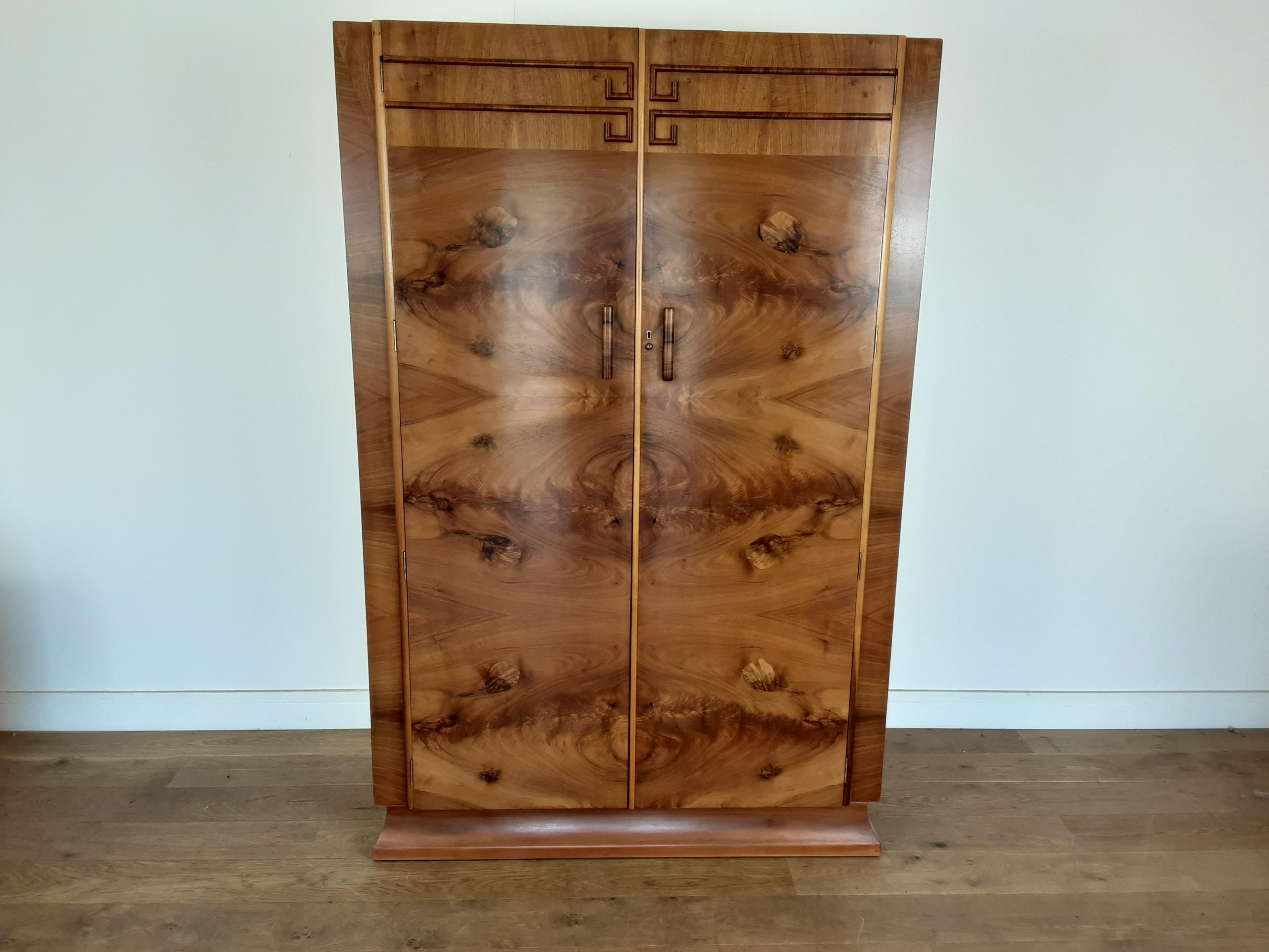 Art Deco bedroom set
comprising of a Wardrobe, a linen press and a dressing table.
Beautiful figured walnut wardrobe, two-door wardrobe with single shelf compartment to the left with hanging rail below, further pull out hanging rail to the right,