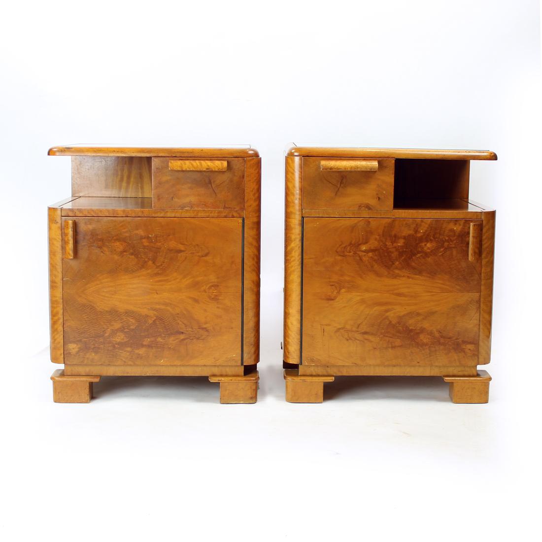 These are unique bedside tables, very typical for the Art Deco era. Produced in 1930s in Czechoslovakia. The tables are made of oak wood with walnut veneer on the whole tables. Full of amazing details and style. There is a drawer in the top side of