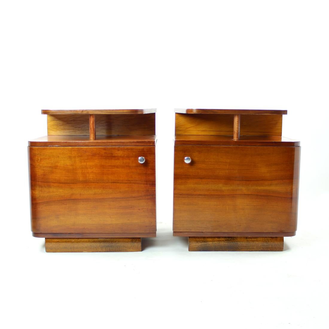 Beautiful and completely restored set of two bedside tables. Produced in the 1930s by UP Zavody. Stylish combination of the art deco/ functionalism style. Elegant design. Produced in oak and walnut combination of wood. There is a floating shelf on