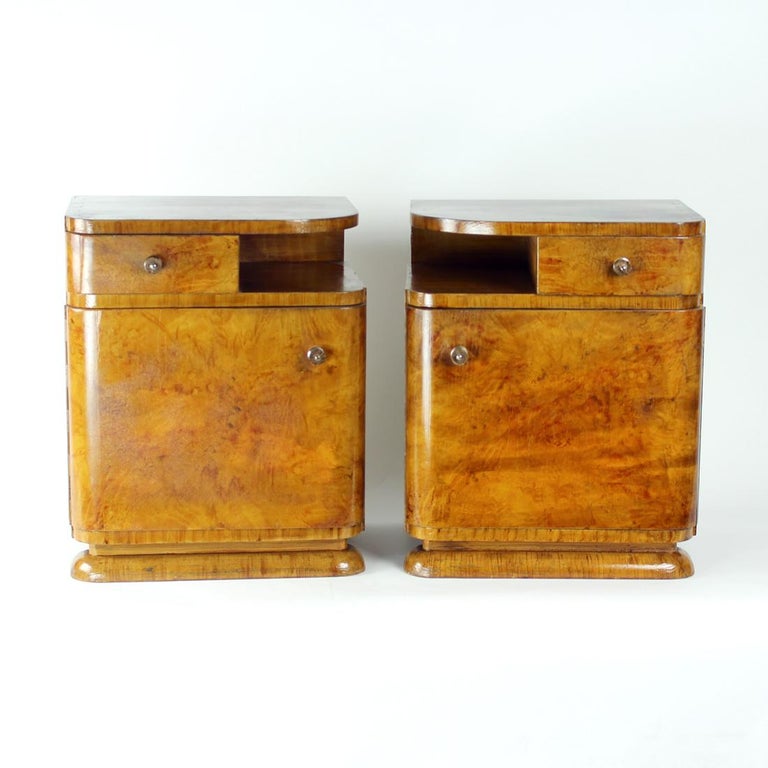 Quite unique set of two bedside tables from art deco era. Produced in Czechoslovakia in 1940s, the tables are made of wooden construction full of beautiful, typical art deco lines and details. Curved edges, small drawer, original resi handles and so
