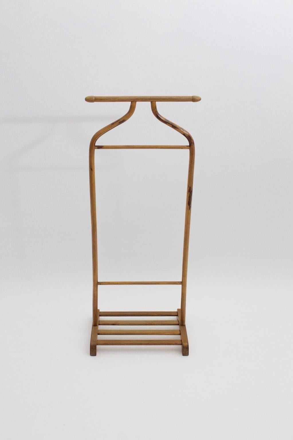 The elegant vintage beech valet or coat rack shows all features, what you are looking for.
Two racks and one reling for your clothes and a parking space with wooden slats for your shoes.
Furthermore the valet was designed and executed by Thonet