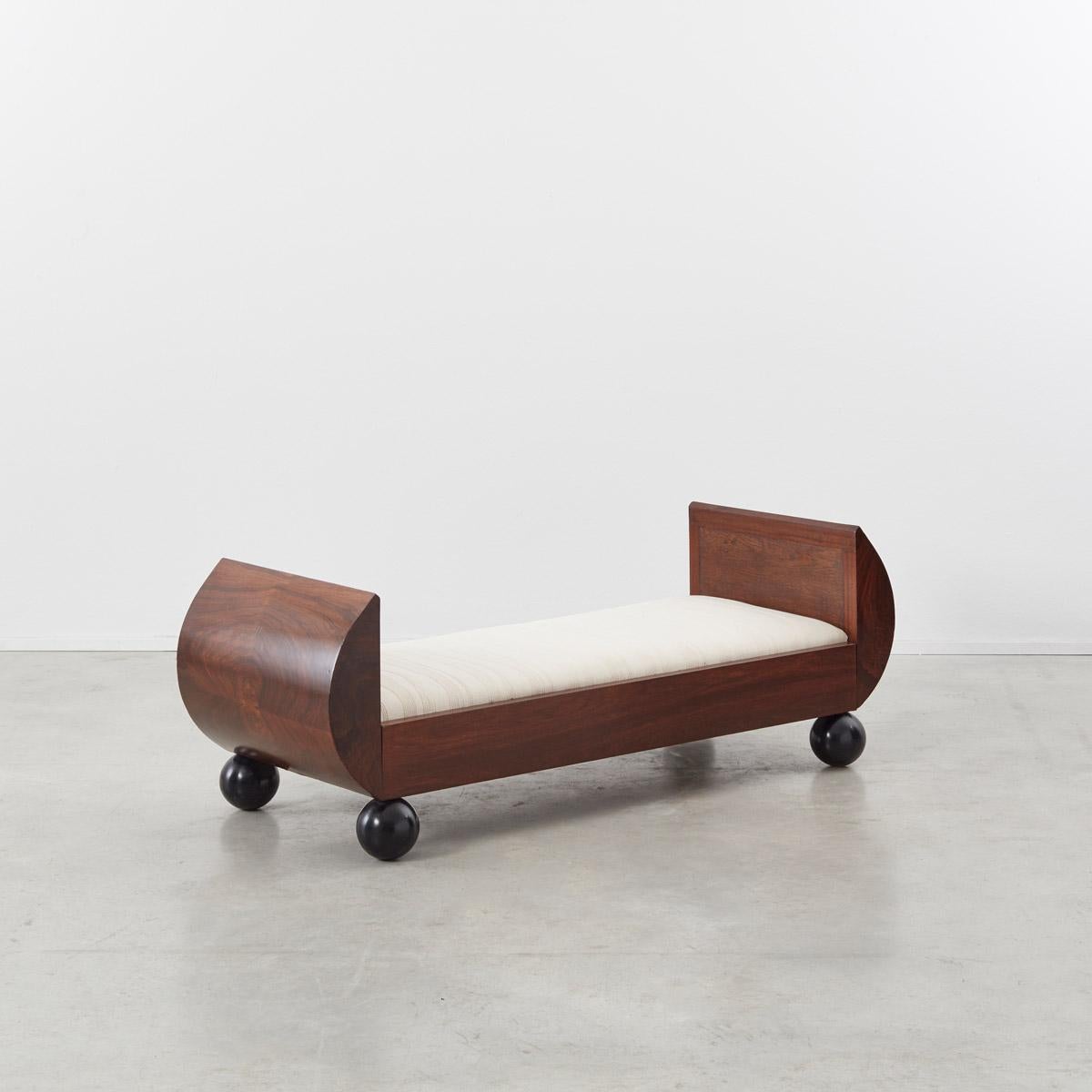 This beautiful 1930s Art Deco upholstered bench has a simple stylized form. The piece is comprised of bold geometries typical of the era yet displays a muted palette straying from the prevalent decorative trends of the time. The upholstered seat,