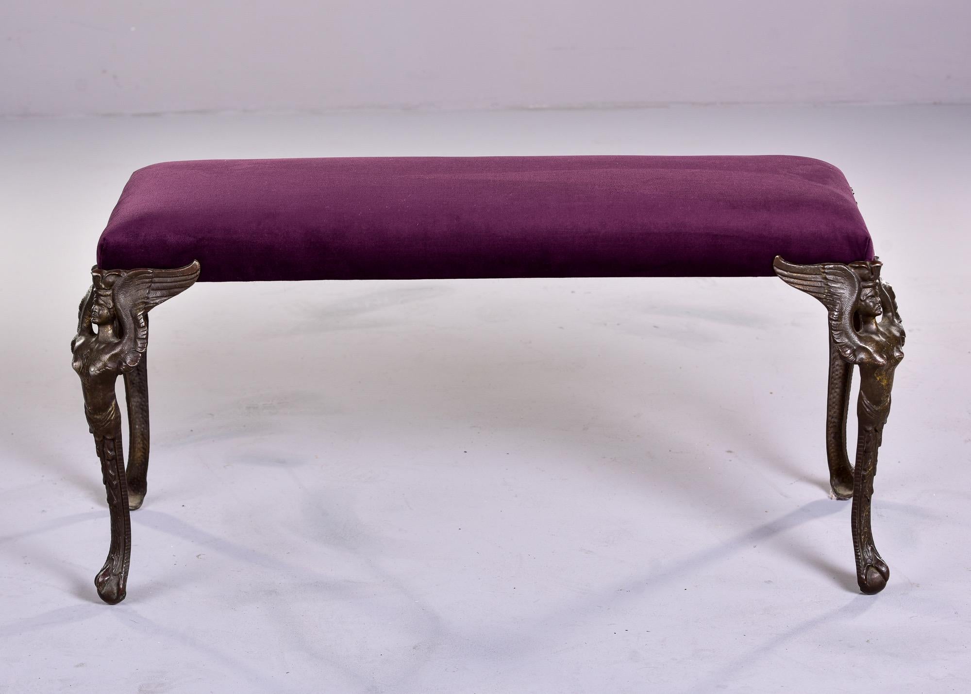 Found in the US, this circa 1930s bench features dramatic Art Deco era cast bronze legs of winged female - could be Nike, the goddess of victory. Bench has been reupholstered in aubergine velvet fabric. Unknown maker.
 