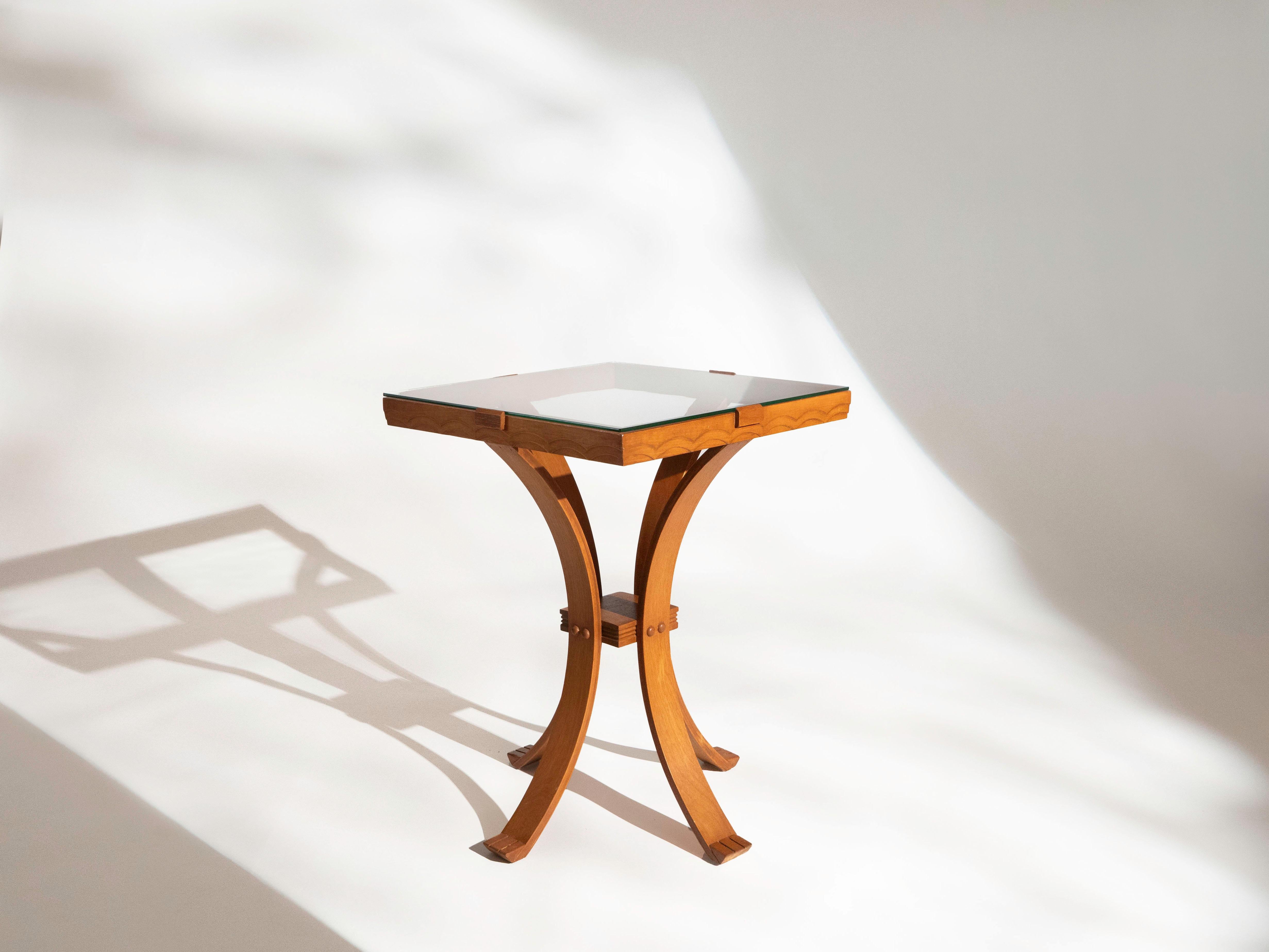 Art Deco side table with incredible detailing. Made circa 1940's. Bentwood legs with paw like feet. The top rim of the table is carved wood that creates a continuous border. The glass is kept in place by sculpted wood pieces on each side. The glass