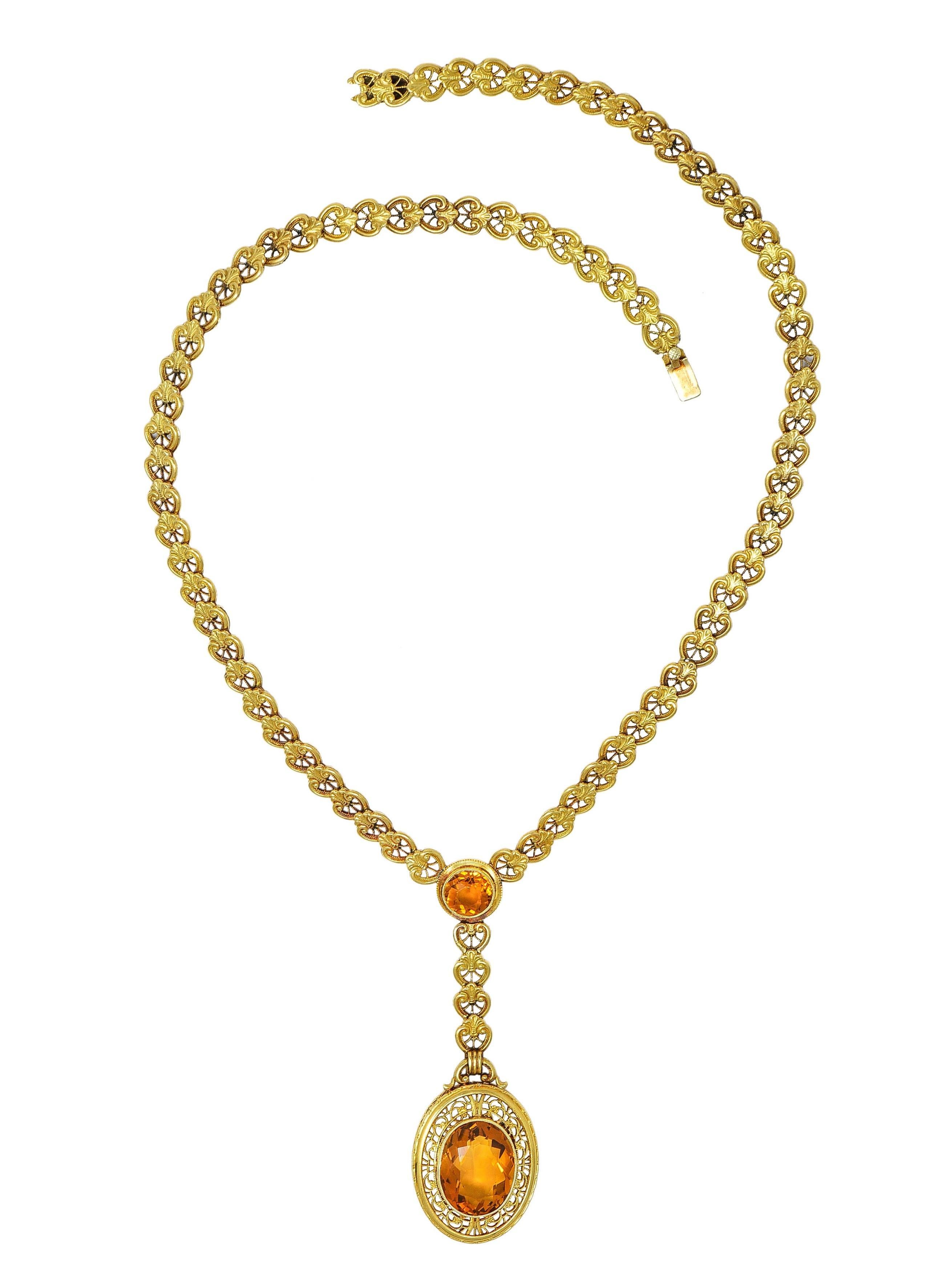 Comprised of hinged links designed as scrolling lotus motifs centering a citrine station 
Round cut and weighing approximately 1.57 carats total - set in a milgrain bezel 
Transparent medium orange - with disk surround suspending drop
Centering an