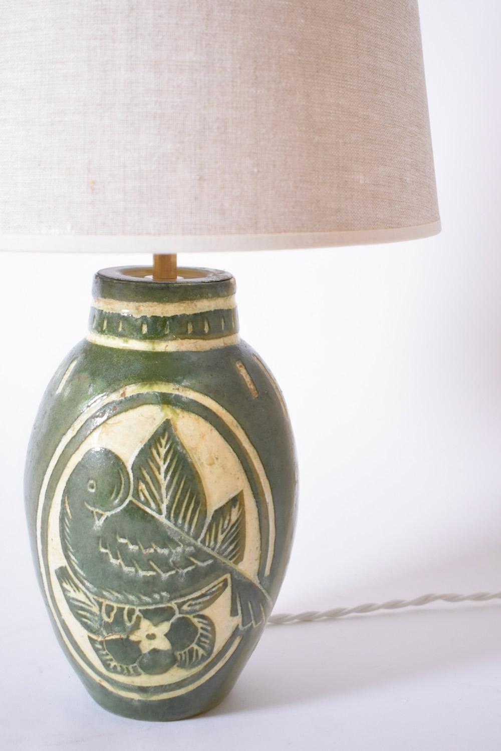 Art Deco ceramic lamp with green enamel decoration of a bird in a reserve. Signed 