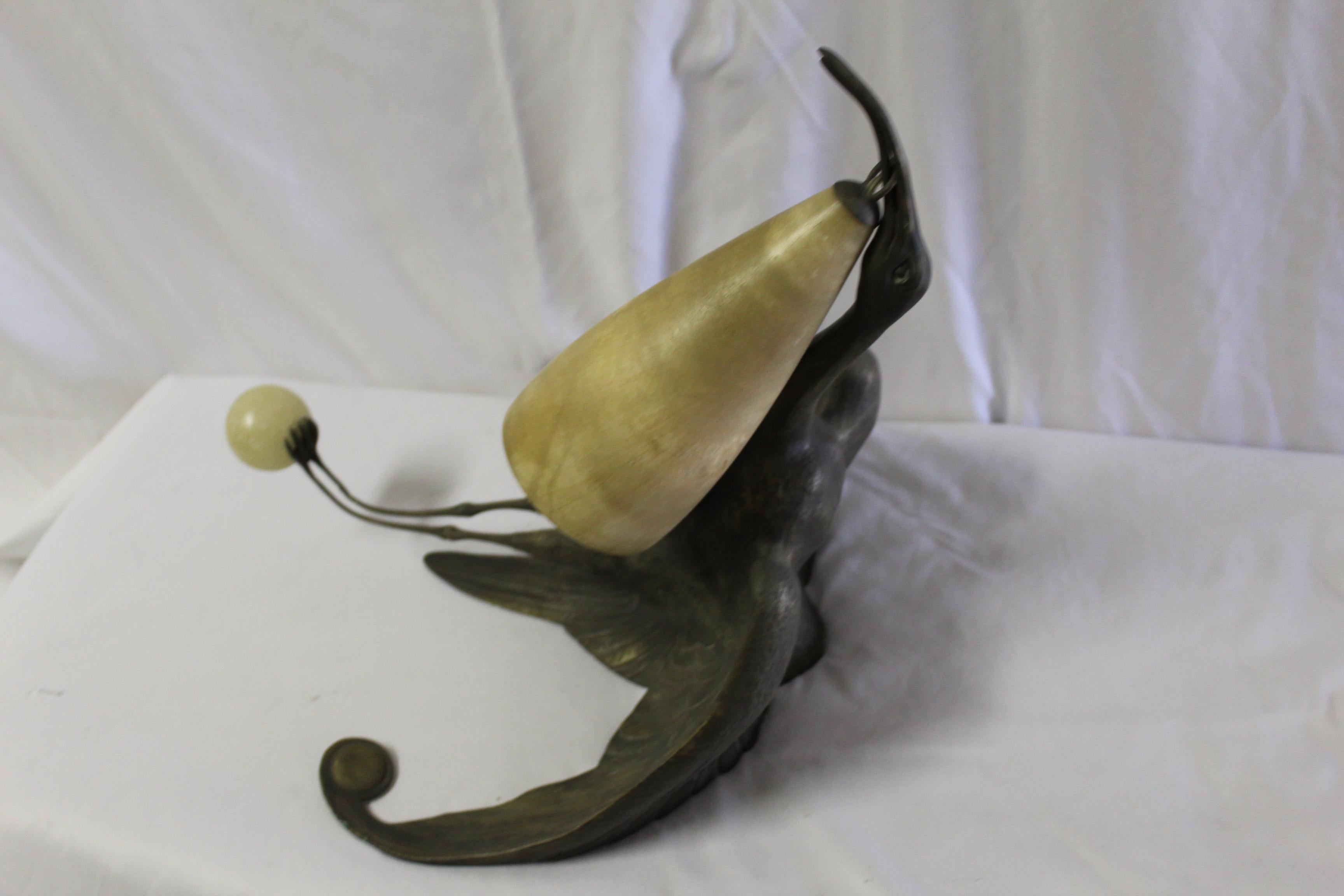 A single Ibis crane sconce. Cast in bronze and bronze patina finish. The shades is Alabaster cone shape. Possibly from France, circa 1950s. Only has single bar hanging mount. A similar pair of antique ones sold in 2015 for $ 104 K. I have not seen