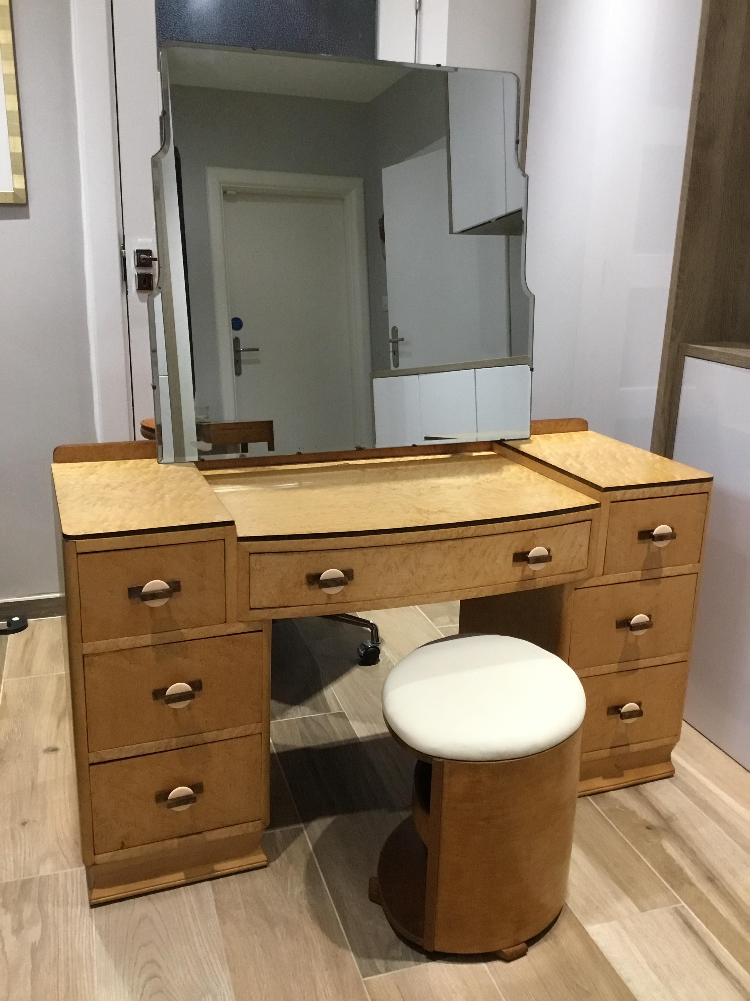 Striking Bird’s-Eye Maple with Walnut Banding Art Deco Dressing Table has a large tilting mirror.
Each of the three surfaces have glass protectors.
There are seven good size clean drawers with brown and cream saturn shaped, phenolic handles, all