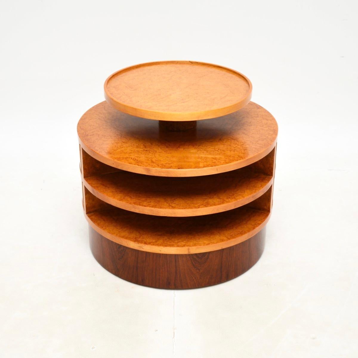 Superbe table d'appoint Art Déco en érable à œil d'oiseau, fabriquée en Angleterre et datant des années 1930.

Il est d'une superbe qualité et présente un design utile et astucieux. La base circulaire est dotée d'une porte qui s'ouvre pour révéler