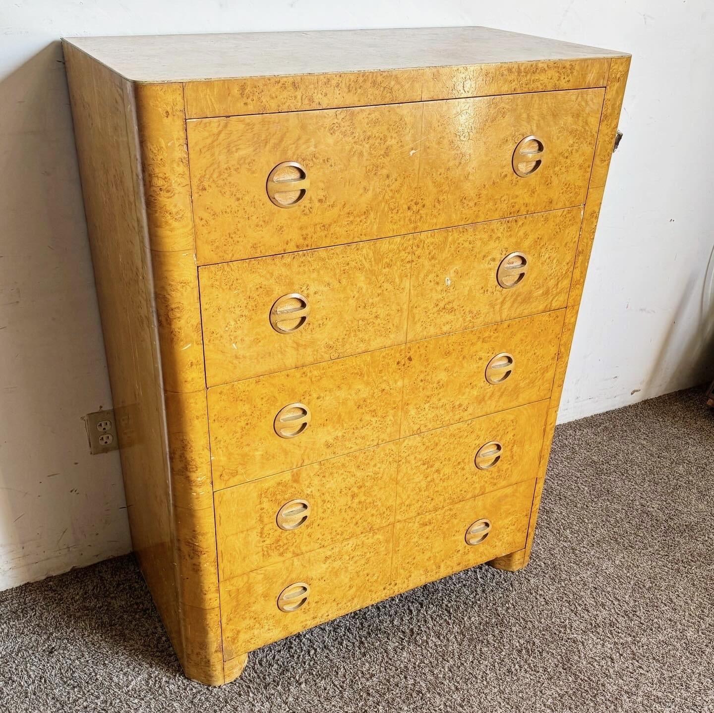 Discover the elegance of the Art Deco era with this Bird's Eye Maple Veneer Highboy. Featuring exquisite veneer work and a sleek design, this highboy offers luxurious aesthetics and practical storage. The bottom drawer is lined with cedar, adding