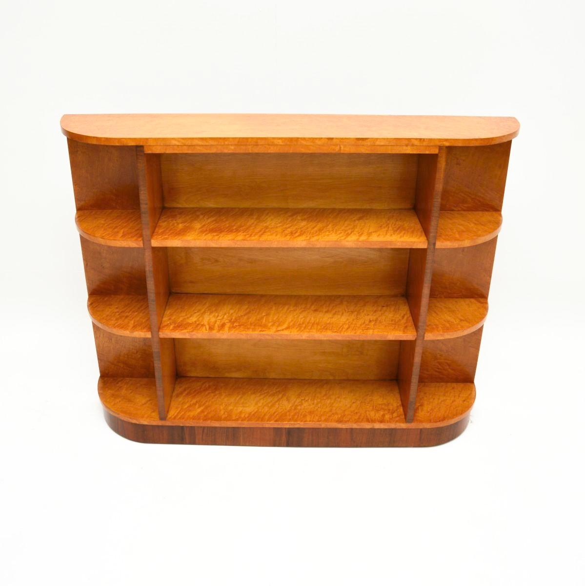 A beautiful and very striking Art Deco Birdseye maple open bookcase. This was made in England, it dates from the 1930’s.

It is of superb quality, with a very useful design. It is slim and low, perfect for use as a side / console table, with lots of