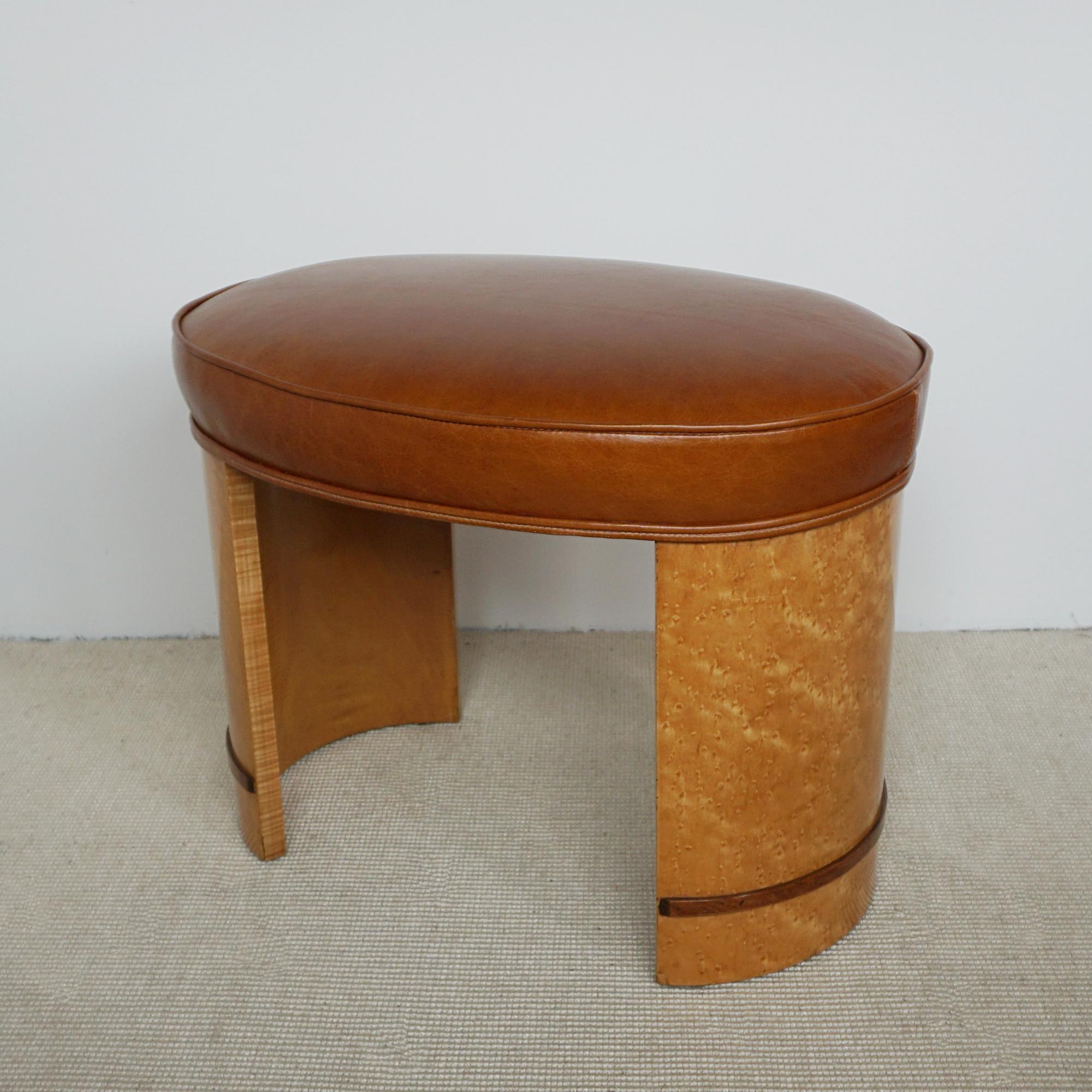 An Art Deco stool. Birdseye maple veneered with walnut banding. Re-upholstered in brown leather. 

All of our furniture is extensively polished and restored where necessary to the highest standards.