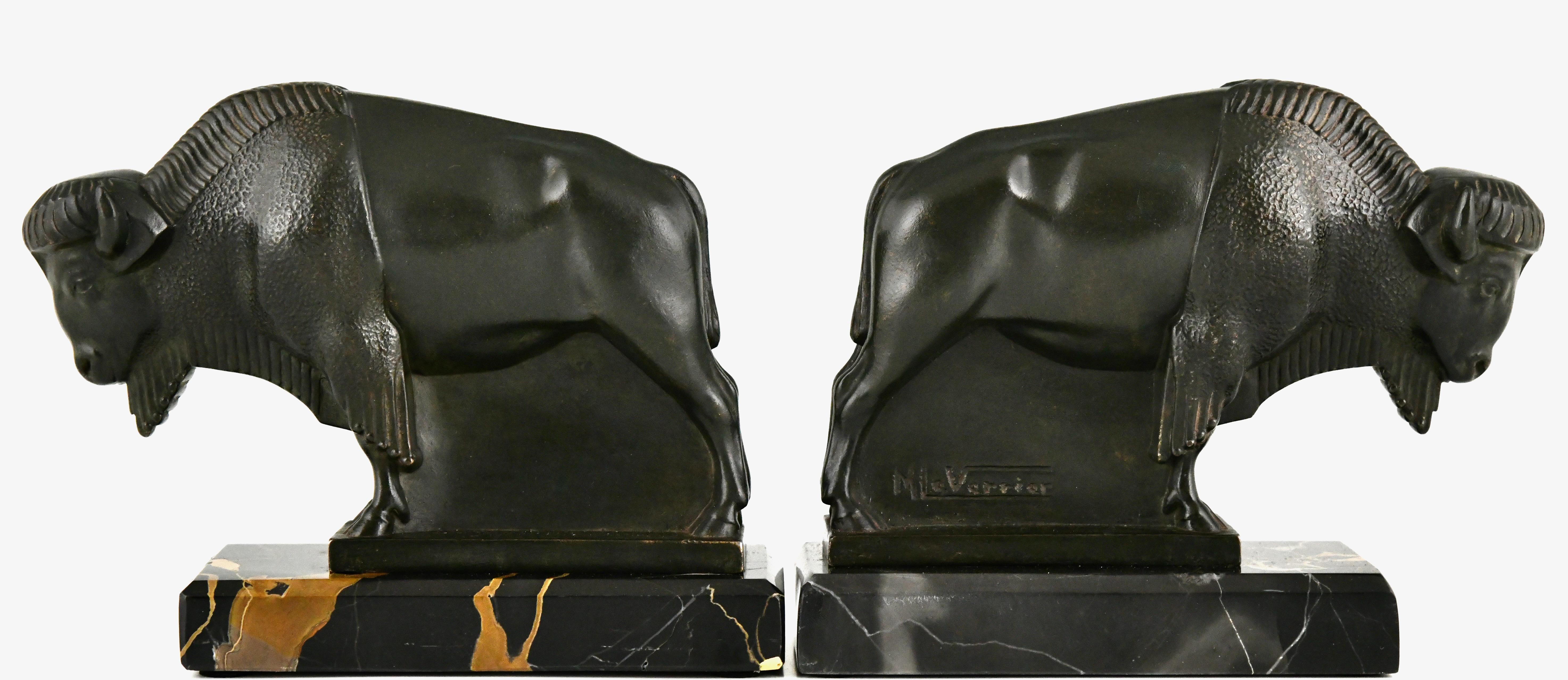 Art Deco bison bookends by the French artist Max Le Verrier. 
Patinated Art Metal on a Portor marble base. 
France 1930

Art Deco sculpture, Victor Arwas, Academy. 
Bronzes, sculptors and founders, H. Berman, Abage. 
Dictionnaire des peintres,
