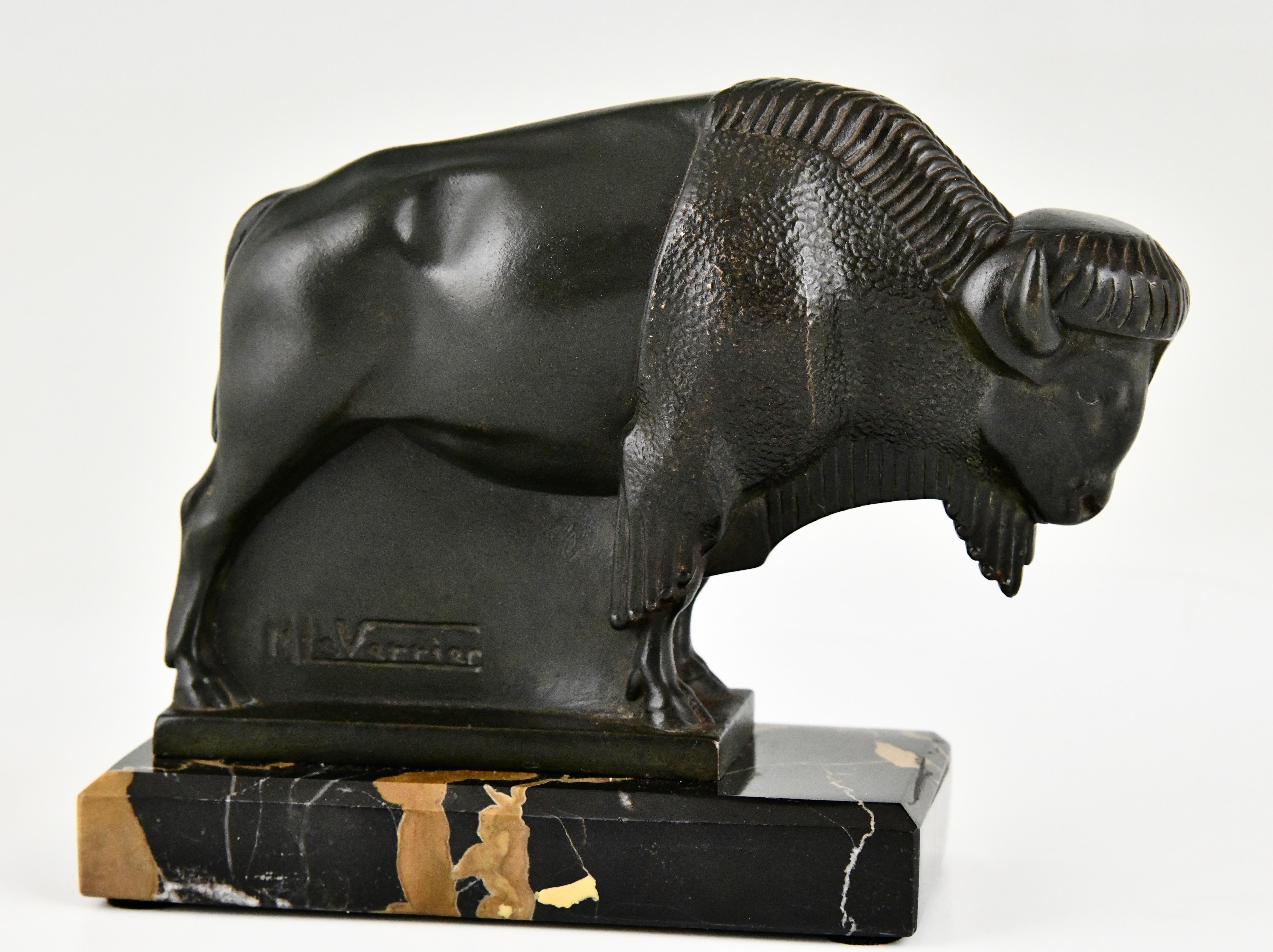 Metal Art Deco bison bookends by Max Le Verrier original 1930 on Portor marble base.  For Sale