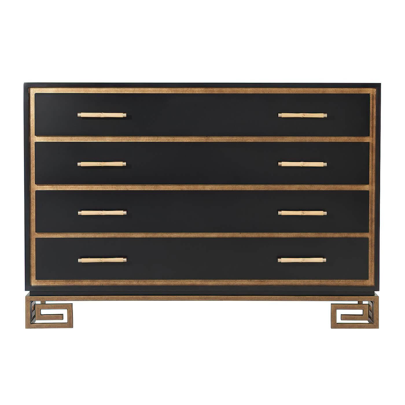A jet black painted and gilt chest of drawers, the rectangular top above four recessed gilt-framed drawers with bamboo stem handles and brass accents, on a vintage gilt steel Greek key base.

Dimensions: 52