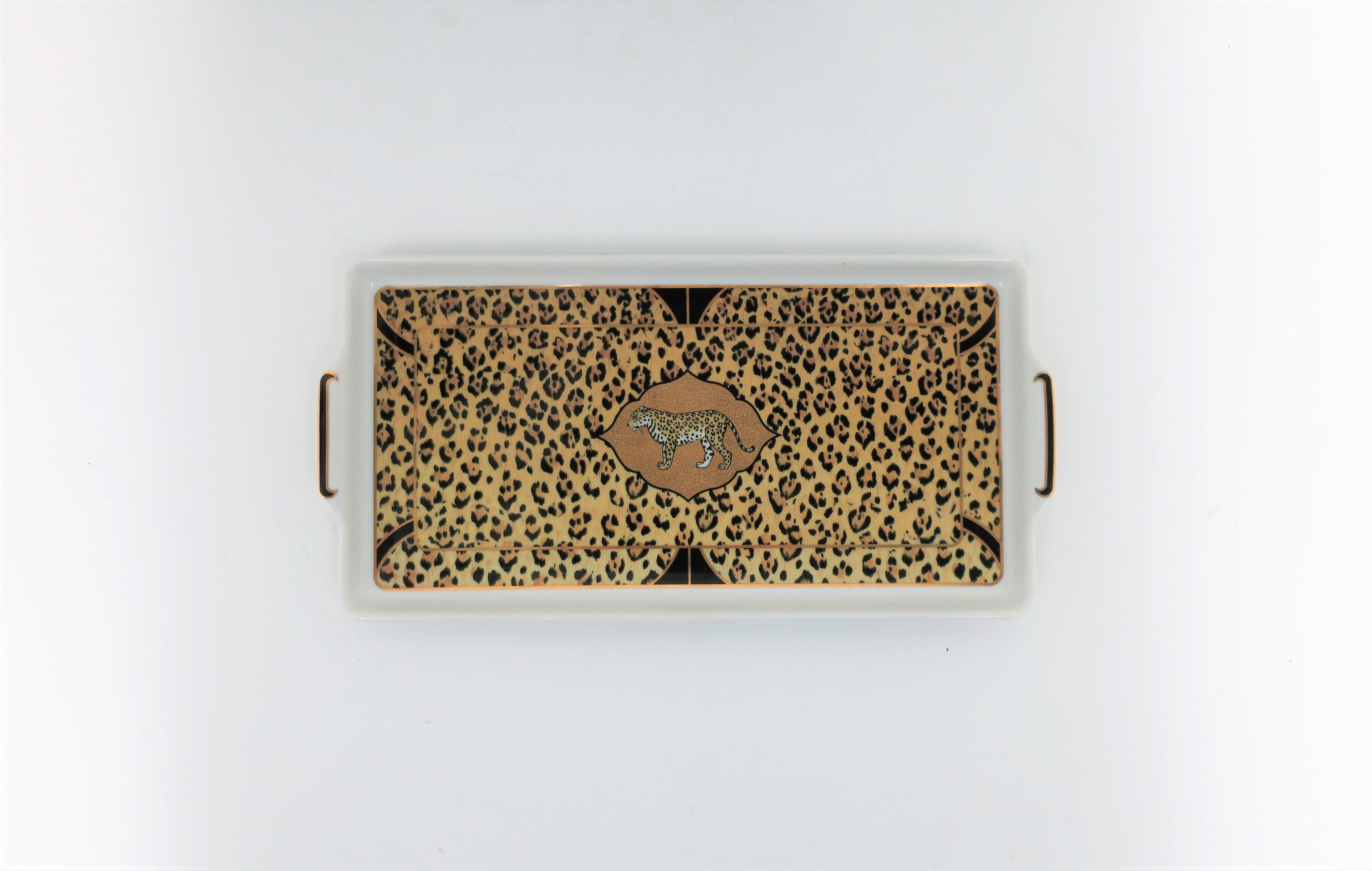 A beautiful '90s designer 'Amazonian Jaguar' cat porcelain rectangular serving tray, by Lynn Chase, 1994, circa late-20th century. A porcelain tray, with animal print design and center jaguar cat, in tan, black and 24-karart gold. Tray can be used