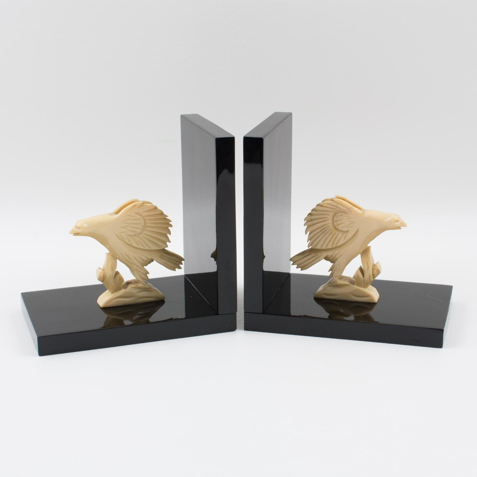 This stunning French Art Deco Galalith bookend set was hand-crafted in the 1930s. The set features two eagles with spread wings. The base of the bookends is in black Galalith, and the hand-carved eagles are in the off-white color of the same