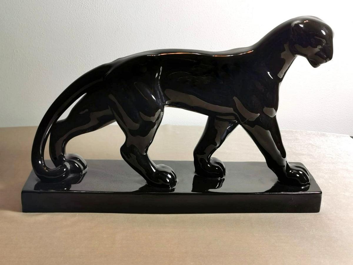 Spectacular and large panther sculpture in polished glaze black ceramic; the animal was depicted in its most Classic superb and imposing bearing; a Classic example of Art Deco that exalted in its artistic expressions the forms, strength, and power