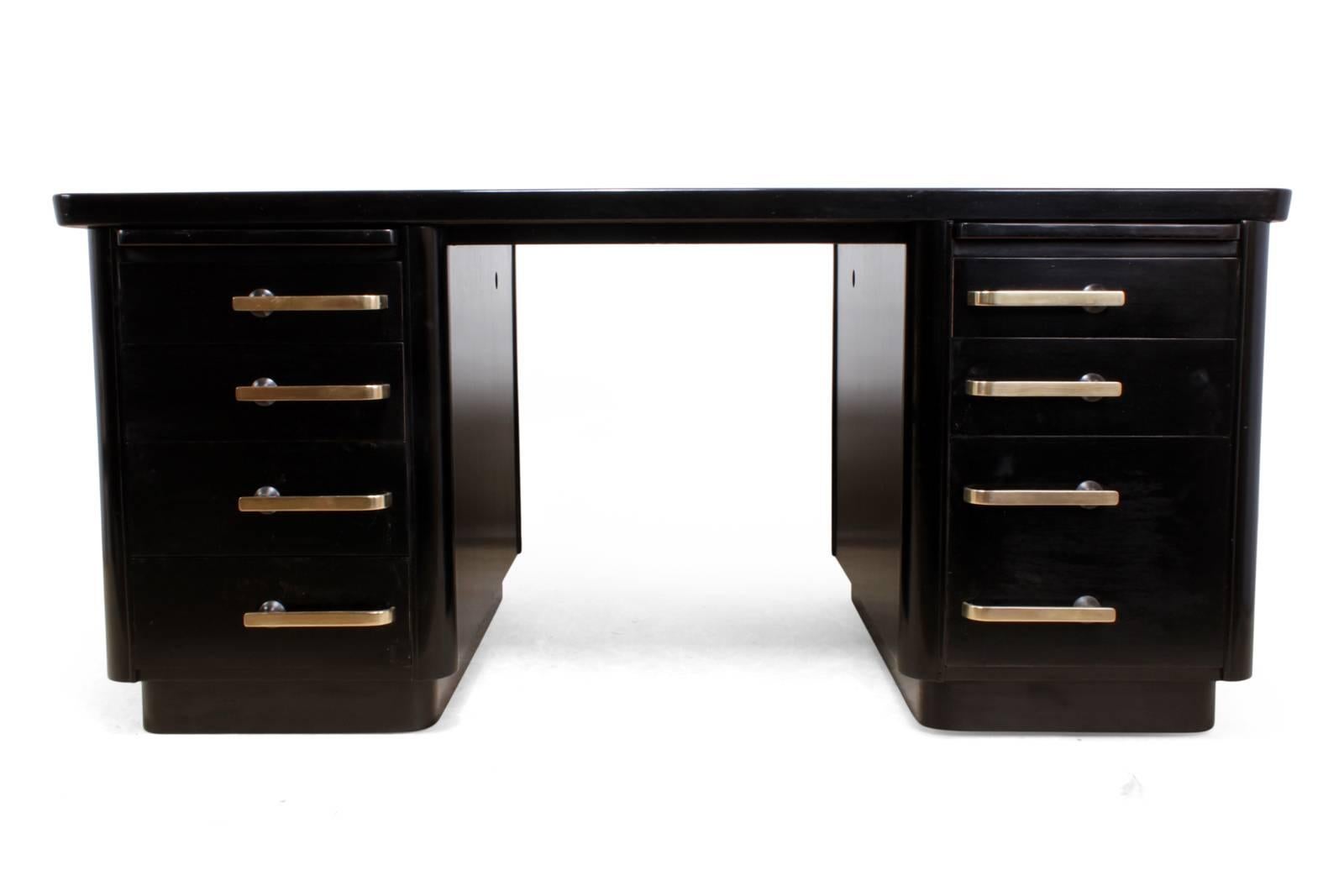 Art Deco black desk 
An Art Deco desk with seven drawers double depth filing drawer to right, two slides and finished in black piano lacquer with complimenting bronze handles and a new leather top, the desk has been fully restored and in excellent