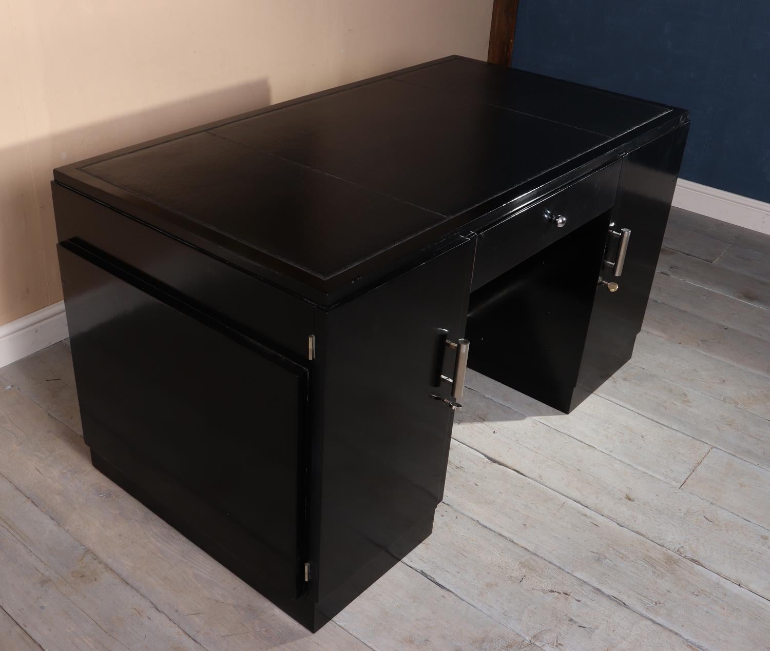 Art Deco black desk, French, circa 1920
A Piano lacquer finish Art Deco desk with new inset leather top two lockable doors left with three drawers behind the desk is in very good condition has some age related marks but has been fully restored and