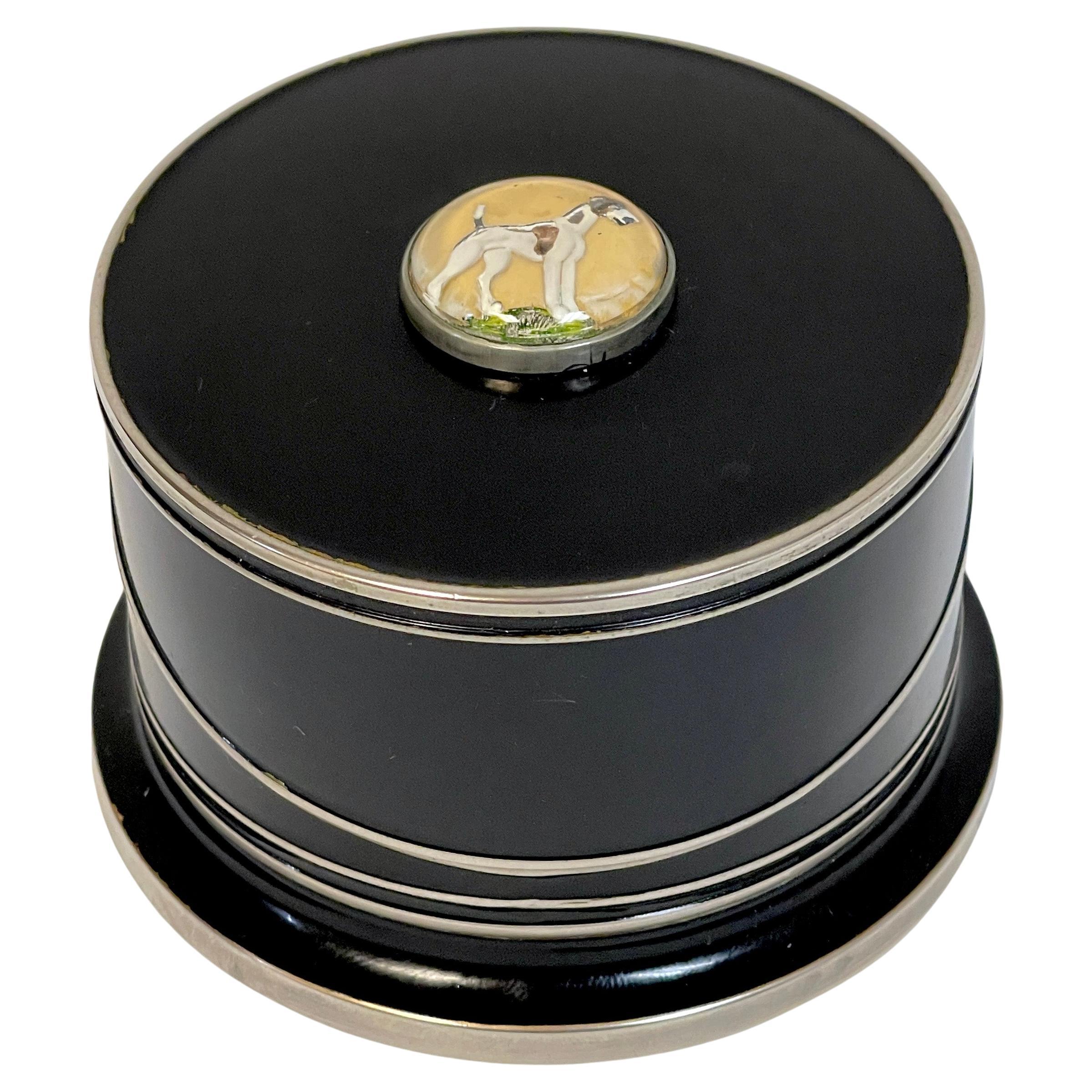 Art Deco Black Enameled & Crystal Dog Intaglio Motif Coaster Box Set 
Germany, circa 1930s 
A unique set of Art Deco useable barware, appearing as a small jewel like round black enameled box with a reverse painted intaglio of Terrirer type of dog.