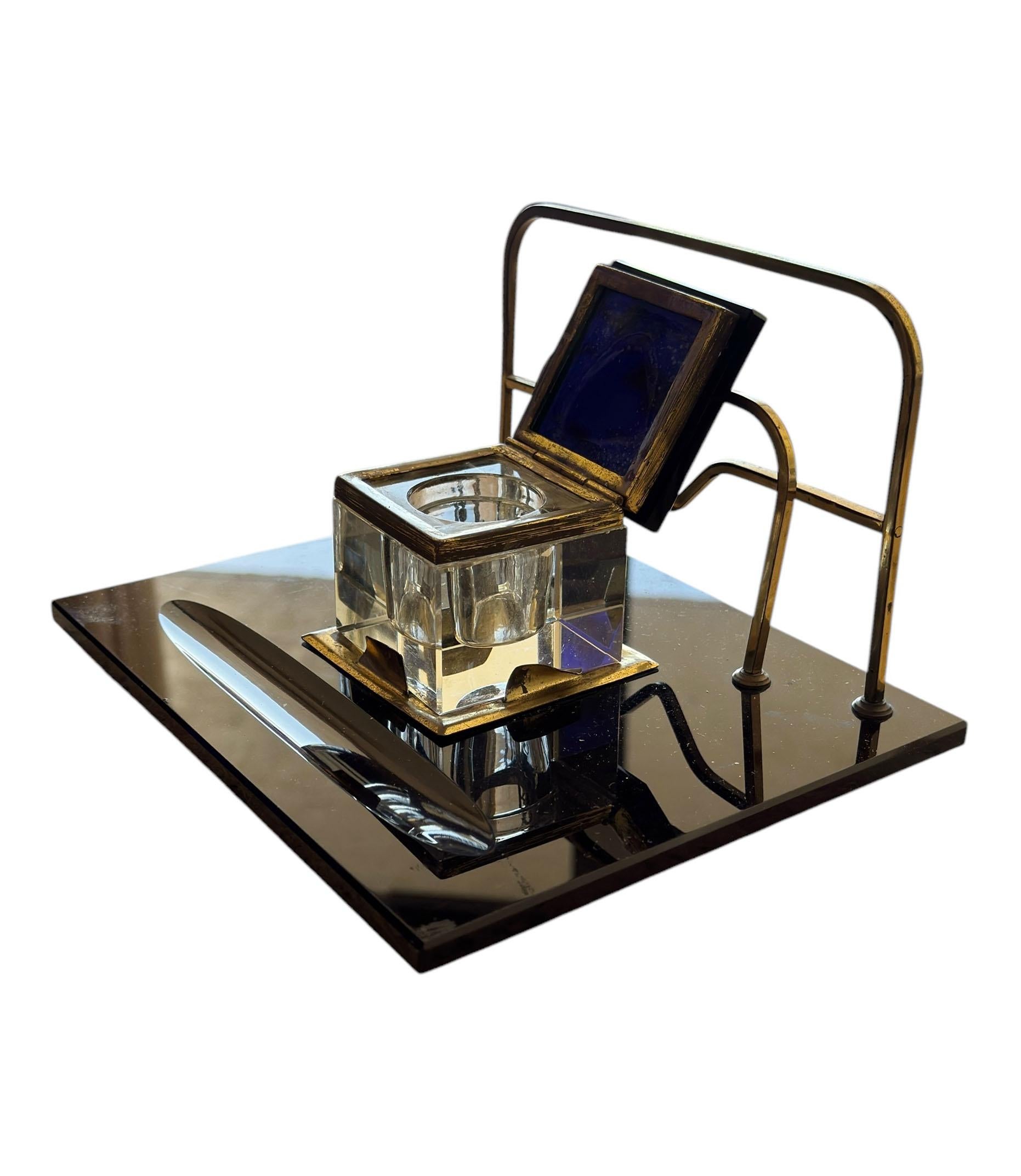 This sophisticated Art Deco black and gold desk set is a stunning example of 1920s elegance. Crafted from sleek black glass with luxurious brass detailing, it exudes timeless style.

Designed for both beauty and function, the set includes a