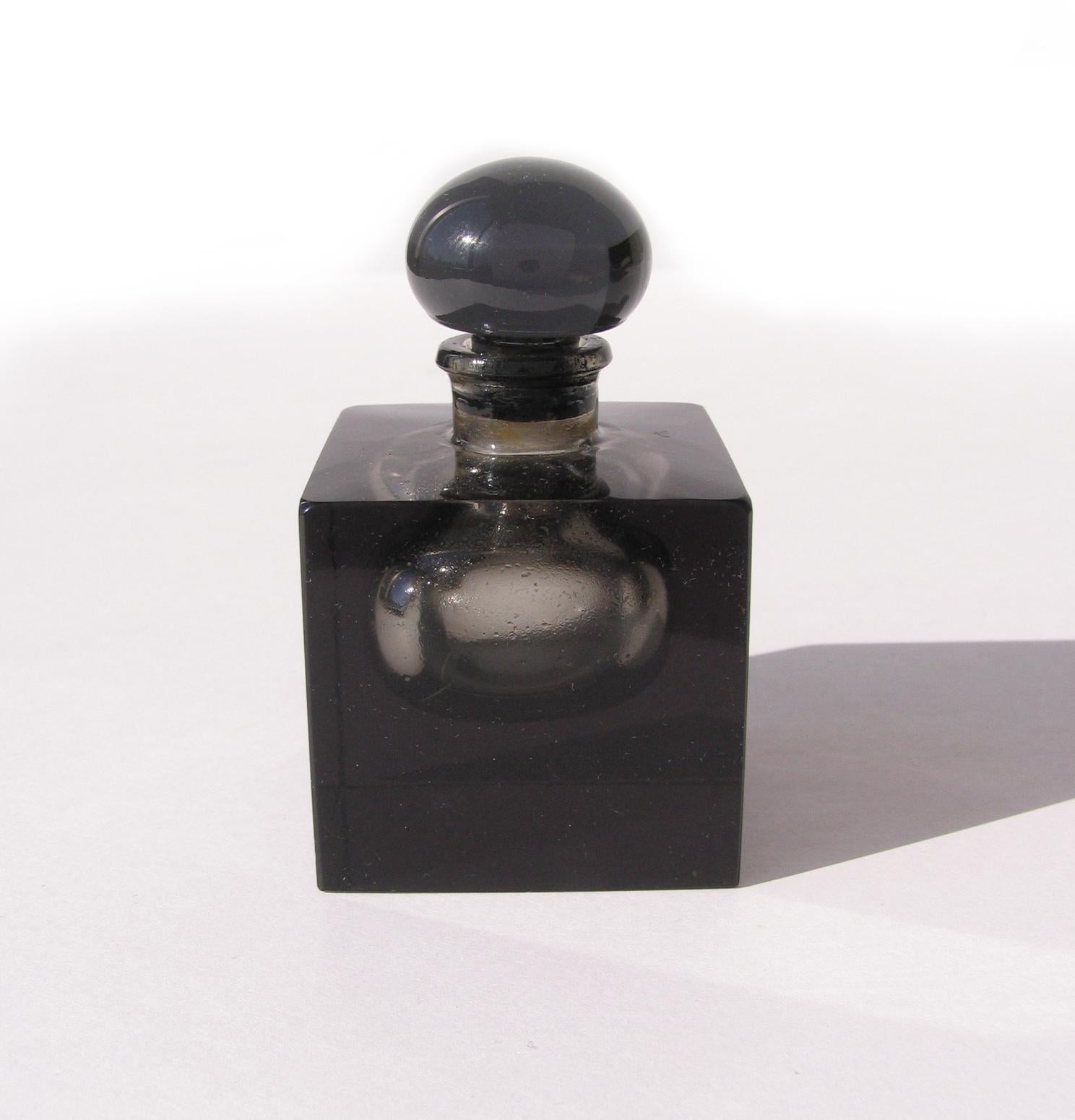 Art Deco square black glass perfume bottle with interior clear sphere. 
Round black glass bottle stopper.