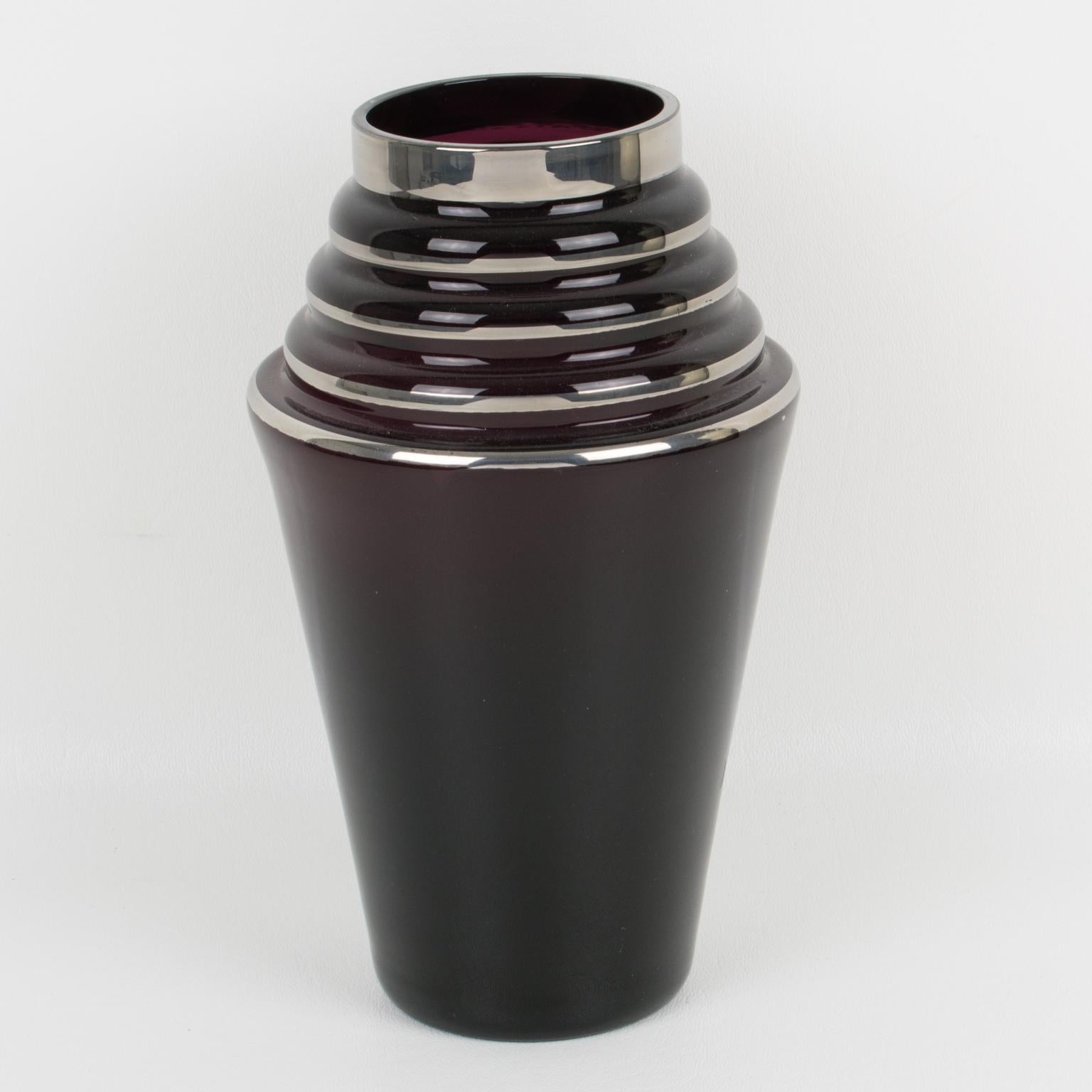This stunning 1930s French Art Deco black glass vase features a silver-decorated design all around, featuring geometric patterns. Please note that although usually named 