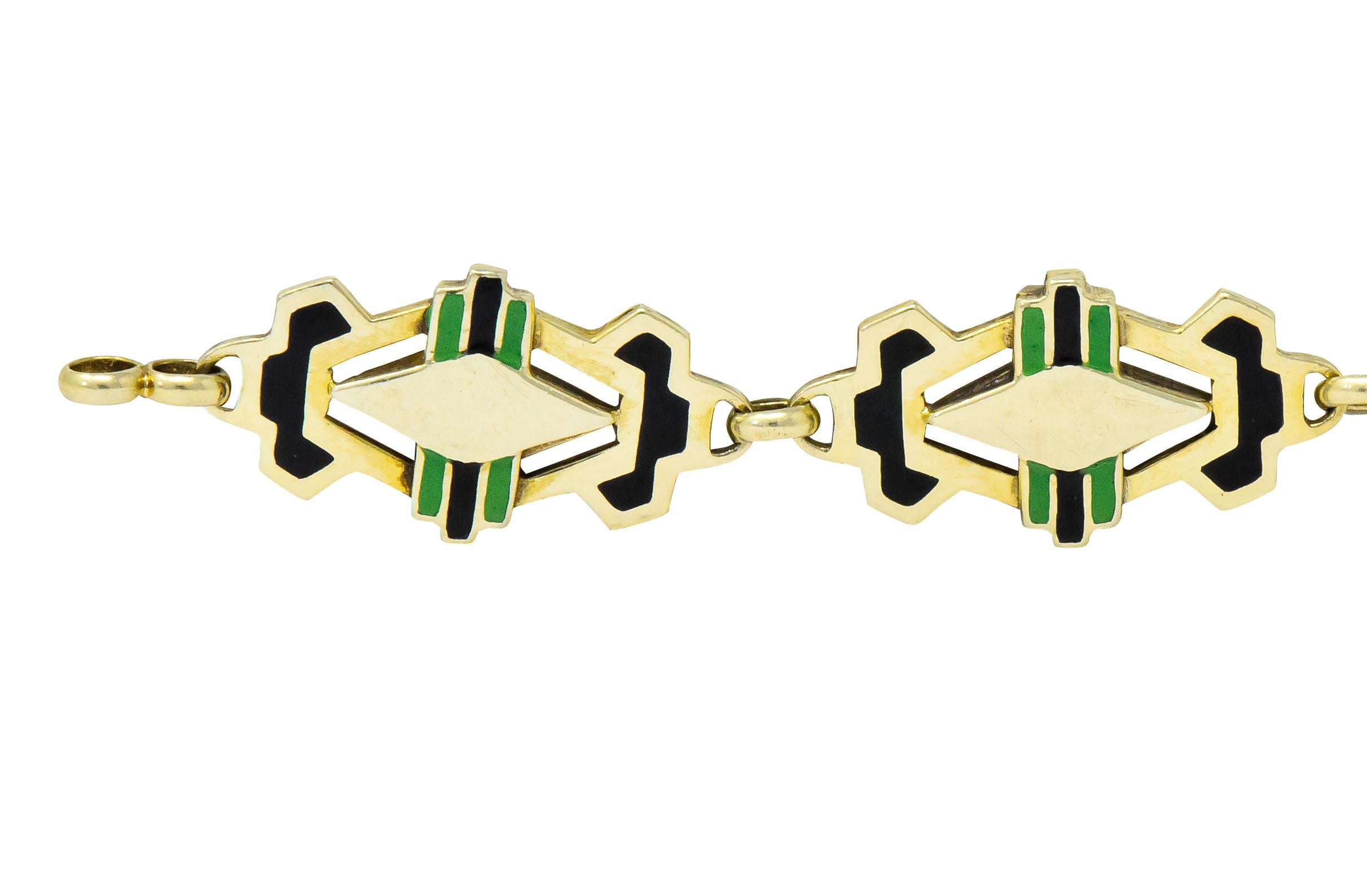 Link style bracelet with each link a stylized, pierced Deco design accented by black and green enamel

Alternating polished spacer links

Completed by spring ring clasp

Stamped 14k

Length: 7 1/4 inches

Width: approx. 3/8 (widest) inch

Total