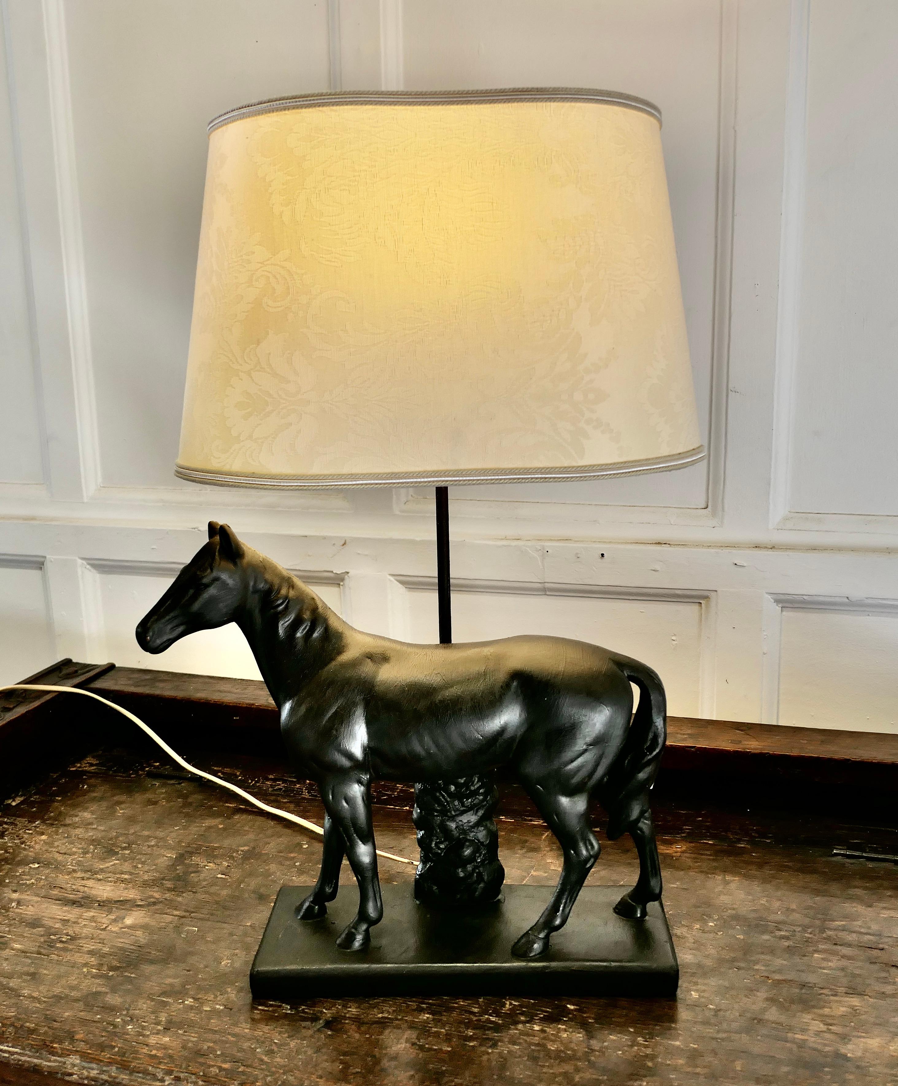 Art Deco Black horse table lamp 

The lamp is made in plaster and shows a very handsome mount, the back of the lamp bares a registration number 
The lamp is in good condition and comes with an oval brocade lampshade 
All working and very