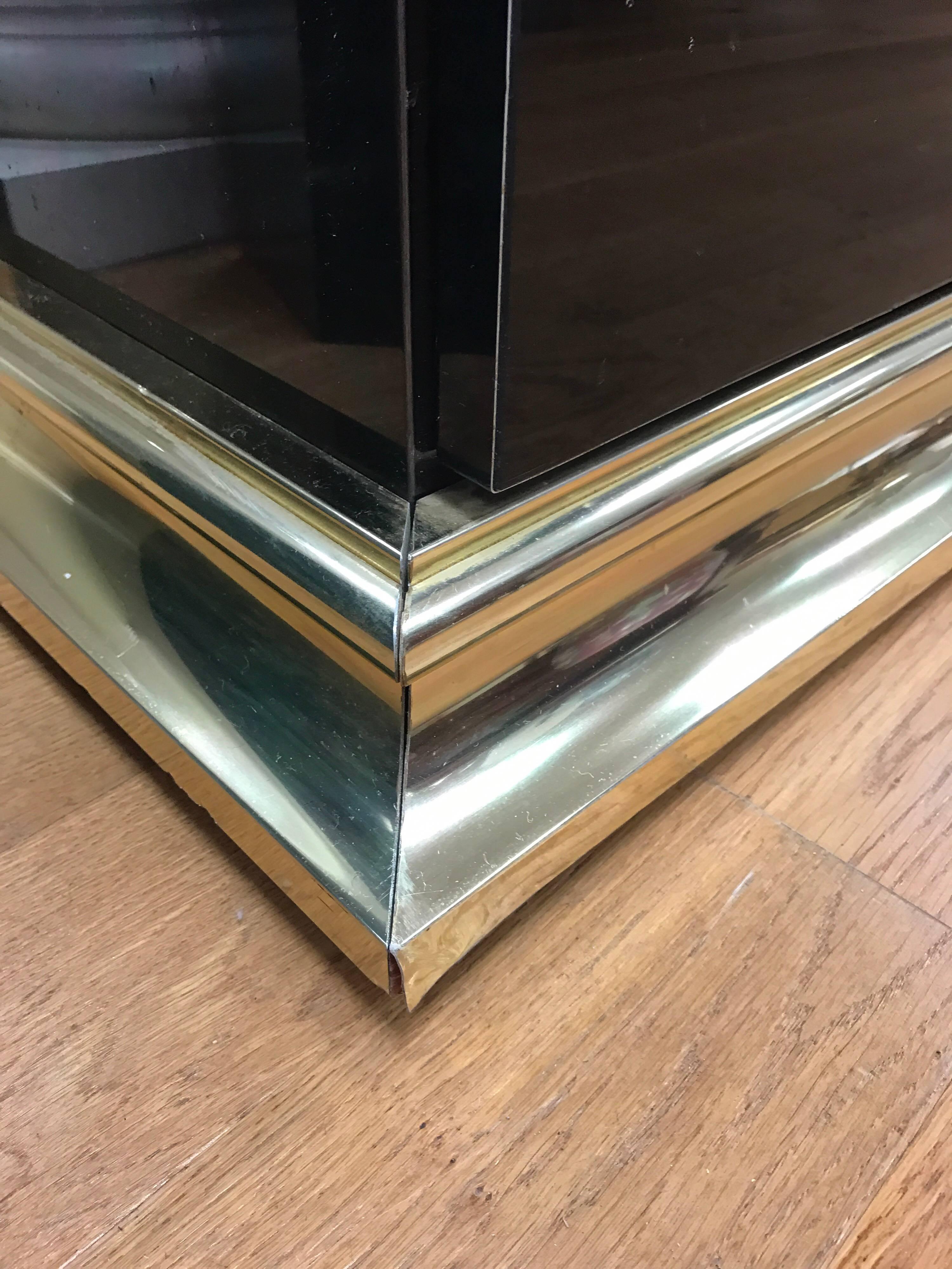 Art Deco style high gloss black with brass hardware and base sideboard. The very definition of sleek! 
Each side has one shelf for optimum storage.
