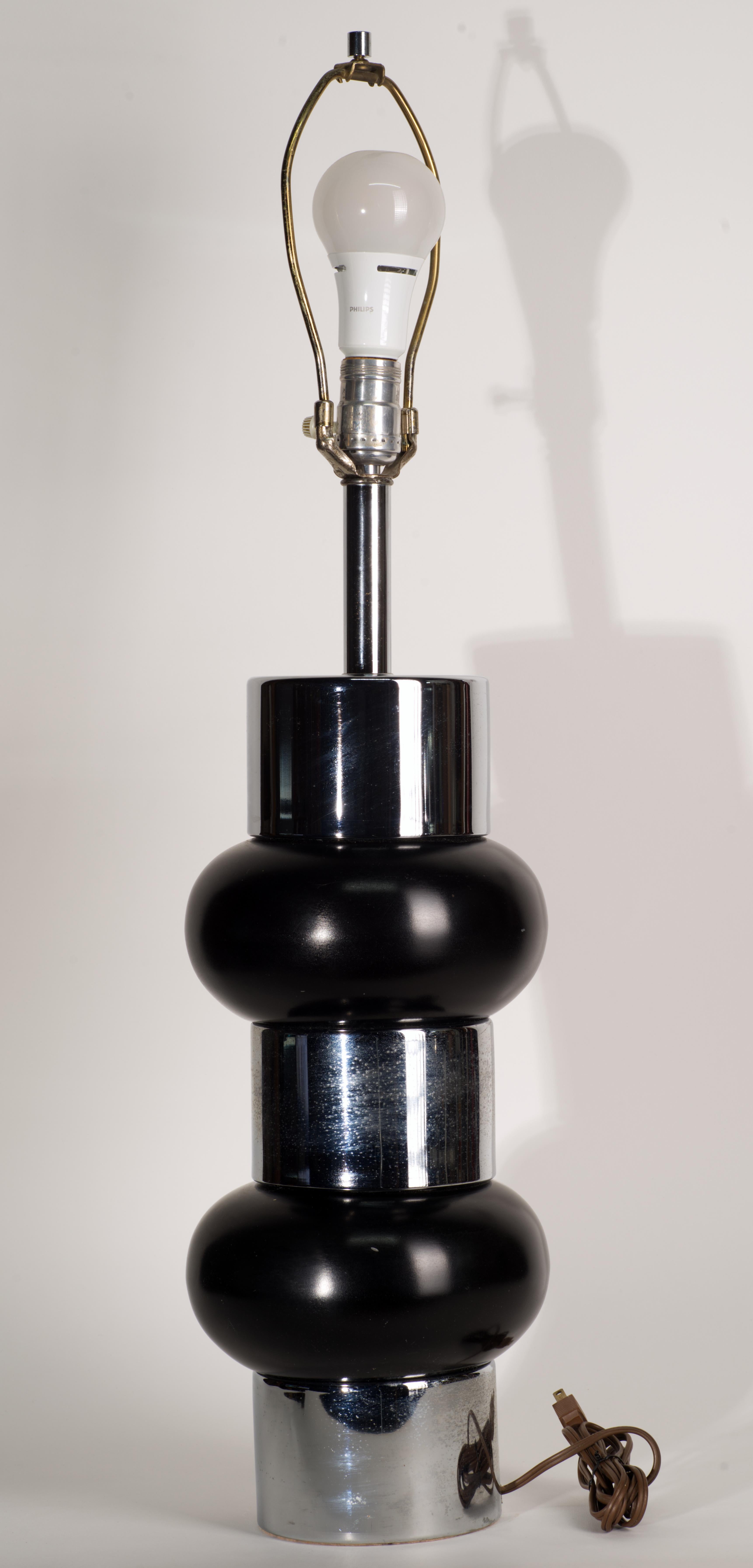  Rare vintage table lamp features two stacked black enameled balls separated by chrome mount with base and top chrome elements in the same size as the mount. The lamp is reminiscent of George Kovacs and Russel Wright lamps in the same style, but the