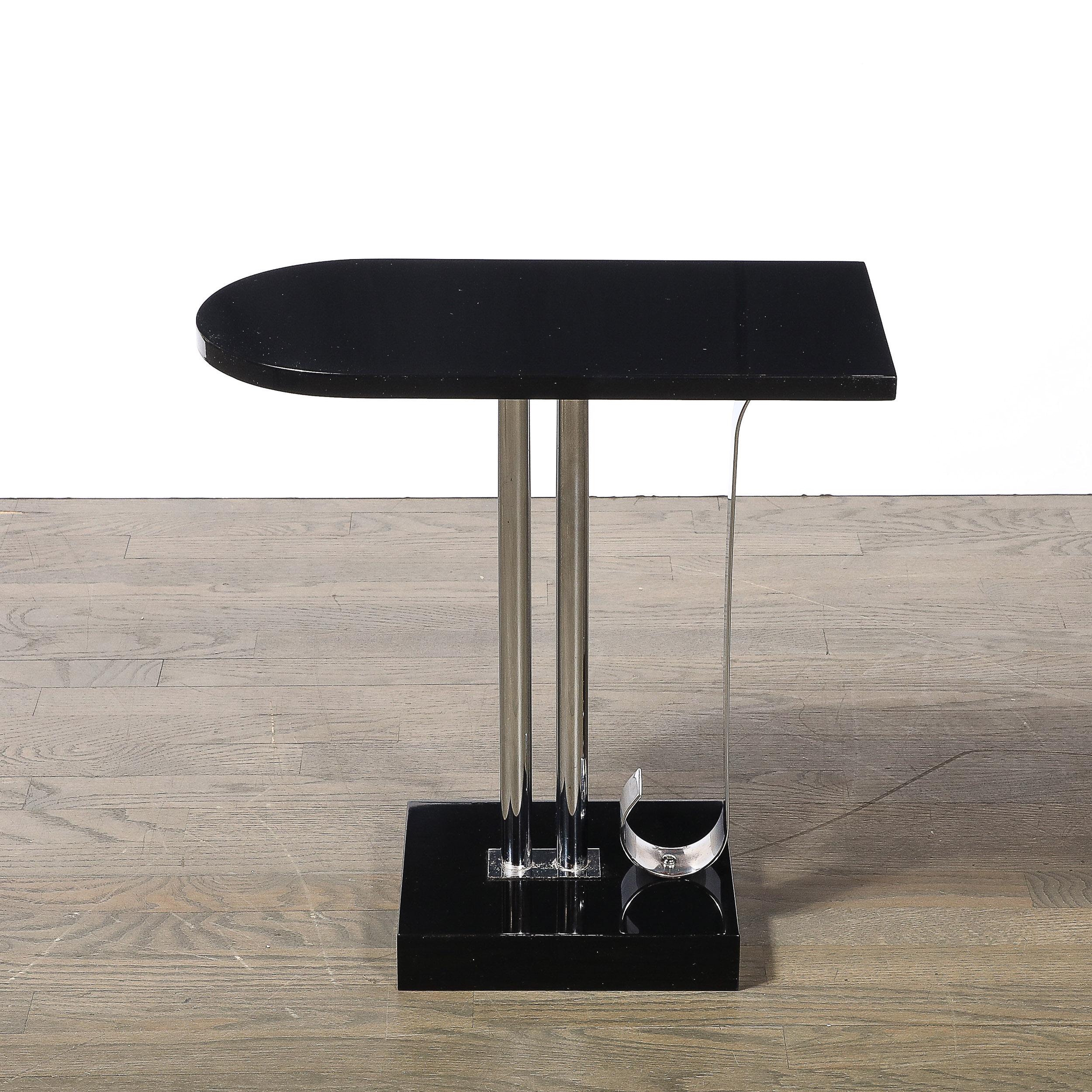 This striking Art Deco side table embodies the timeless elegance and streamlined aesthetic of the 1930s. Designed by Belmet, an iconic American maker, the table features a sleek black lacquer finish complemented by gleaming chrome supports. The