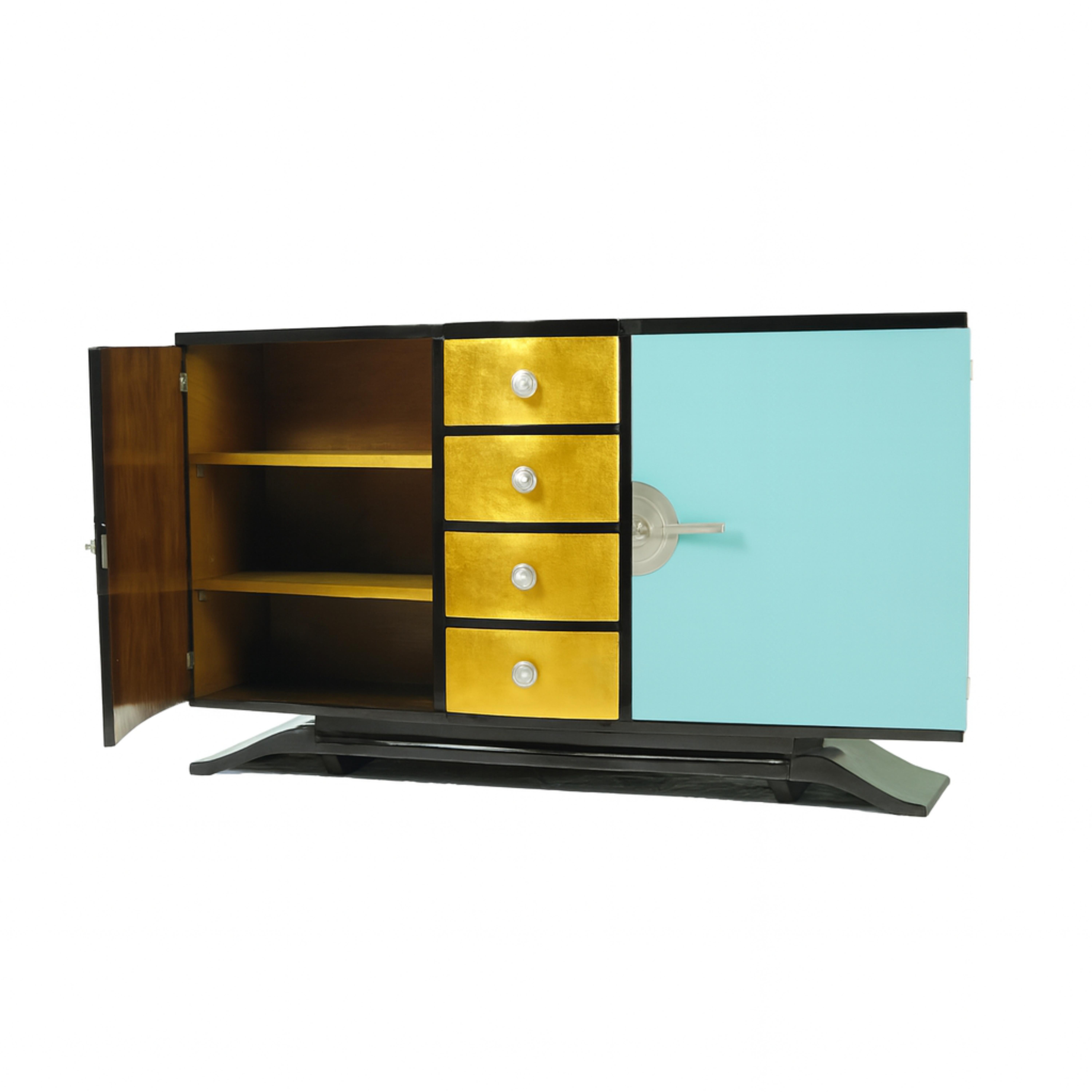 A large 1940s Art Deco sideboard credenza features a remarkable black color blue egg color (color reference #96ded1) and gilt refinishing. It has a spacious cedar interior with two doors and four drawers for dinnerware and cutlery. The piece is
