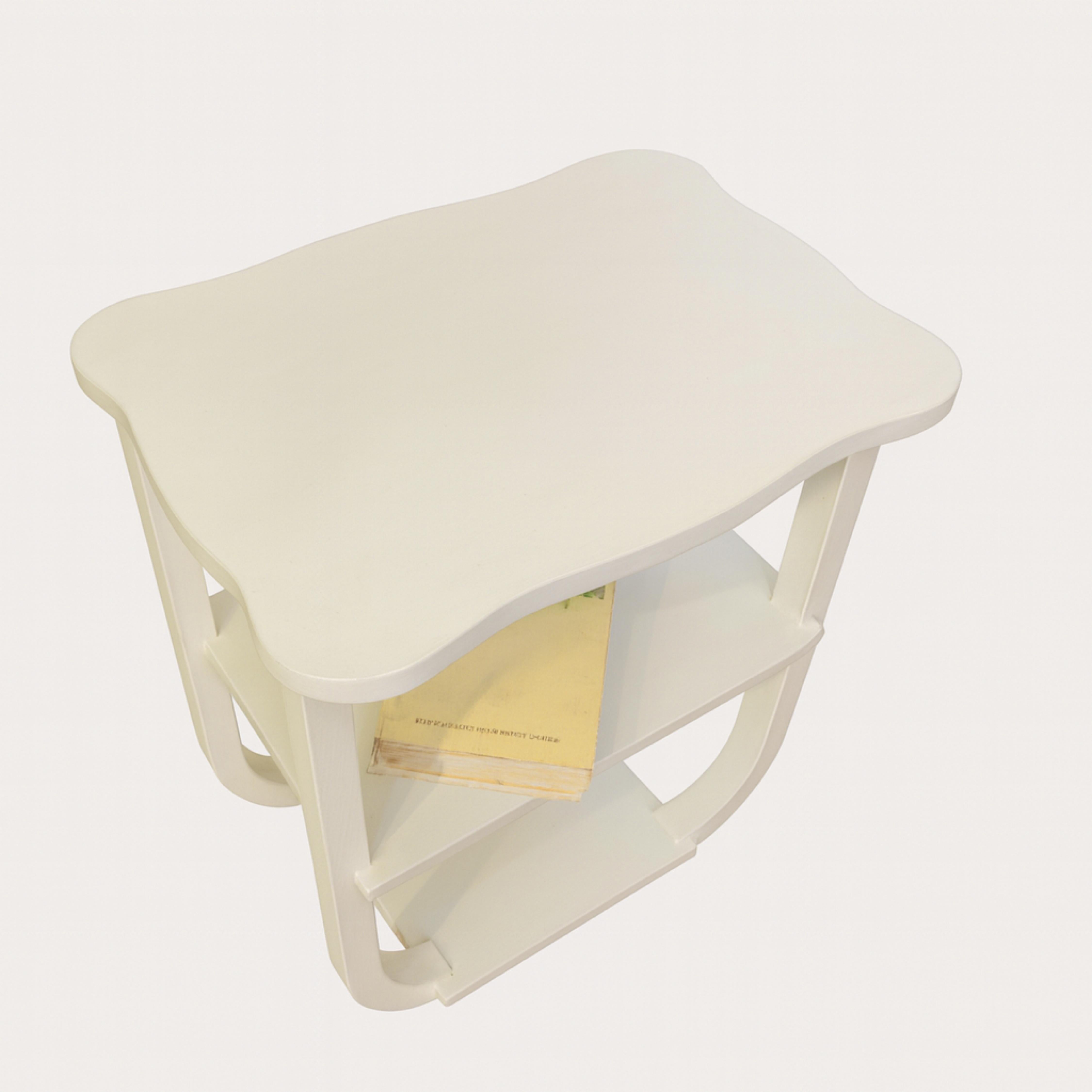 An Art Deco Off White (color reference: #F2F0EF) refinished side table pedestal table from the 20th century. Geometric design with a single drawer for storage and a stylish curved base.

Perfect for bold maximalist interiors — pair it with a riot of
