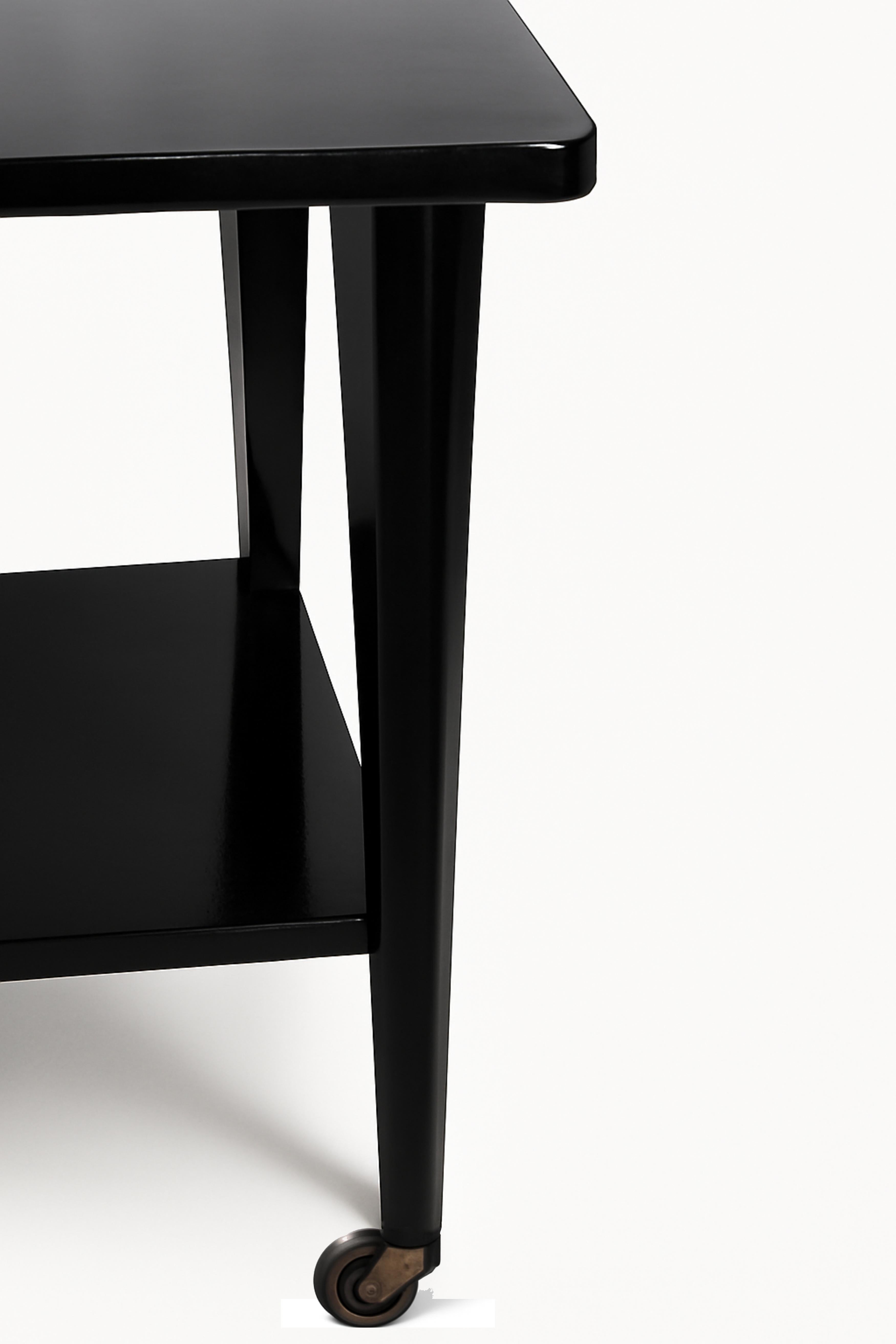 Elegant French black lacquer color Art Deco Tray Table on Removable Wheels from the 20th Century.

Crafted with a richly varnished surface, this exquisite side table embodies the geometric sophistication of the Art Deco era. 

It blends