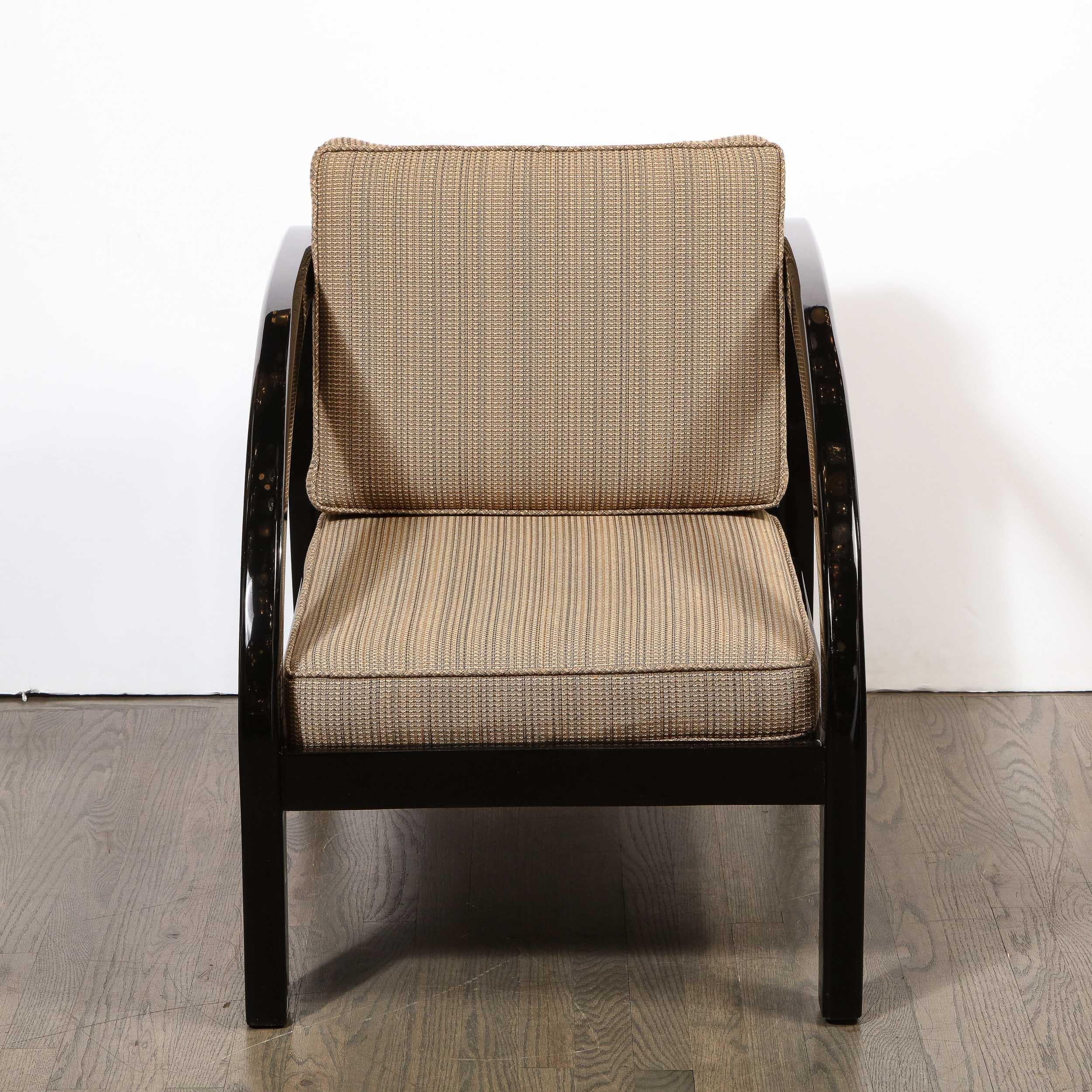 This elegant Art Deco chair was realized by the esteemed maker Modernage Co. in the United States, circa 1930. It features streamlined arms; a volumetric rectangular legs; and a geometric rectangular back with a support slat down the center- all in