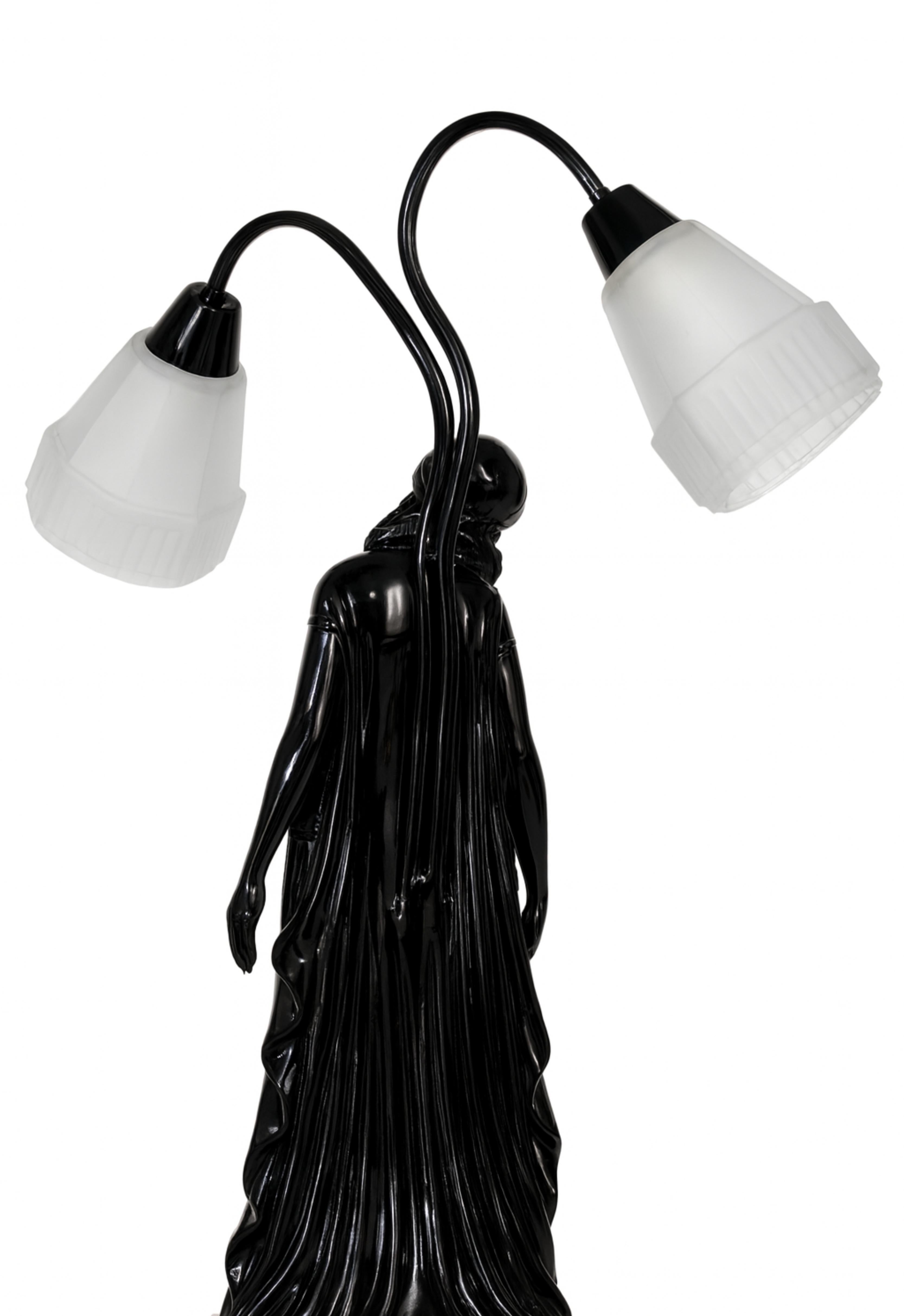 This Art Deco black lacquer refinished table lamp features a sculptural female figure by renowned artist Georges Van De Voorde. The statue, signed 