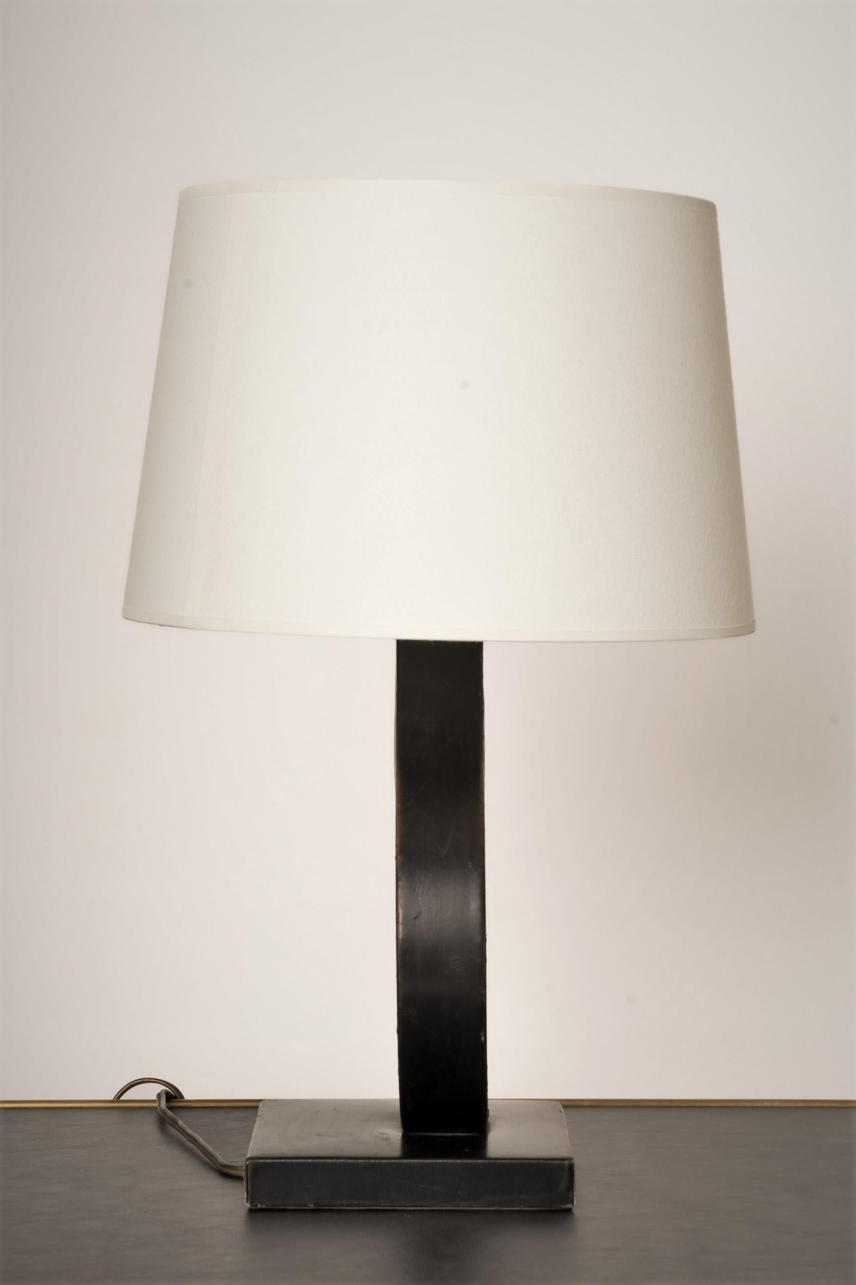 Elegant minimalist table lamp covered table lamp in the style of Jacques Adnet. European socket and wiring. 
Minor structural damages.
This lamp will ship from France and can be returned to either France or to a LIC NY location.
Price does not
