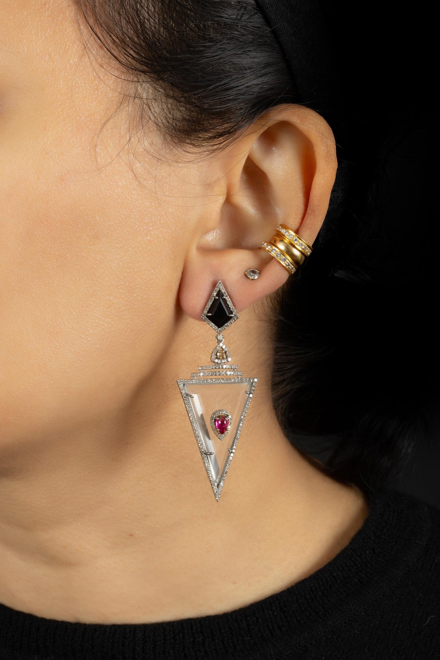 A pretty art deco inspired drop earring set on silver with 14kt gold push backs for the ears.

Single cut diamonds (1.55 carat); Crystal & Tourmaline (18 carat); Black Onyx (0.80 carat)

Very light weight for pierced ears; 5.5 cm in full