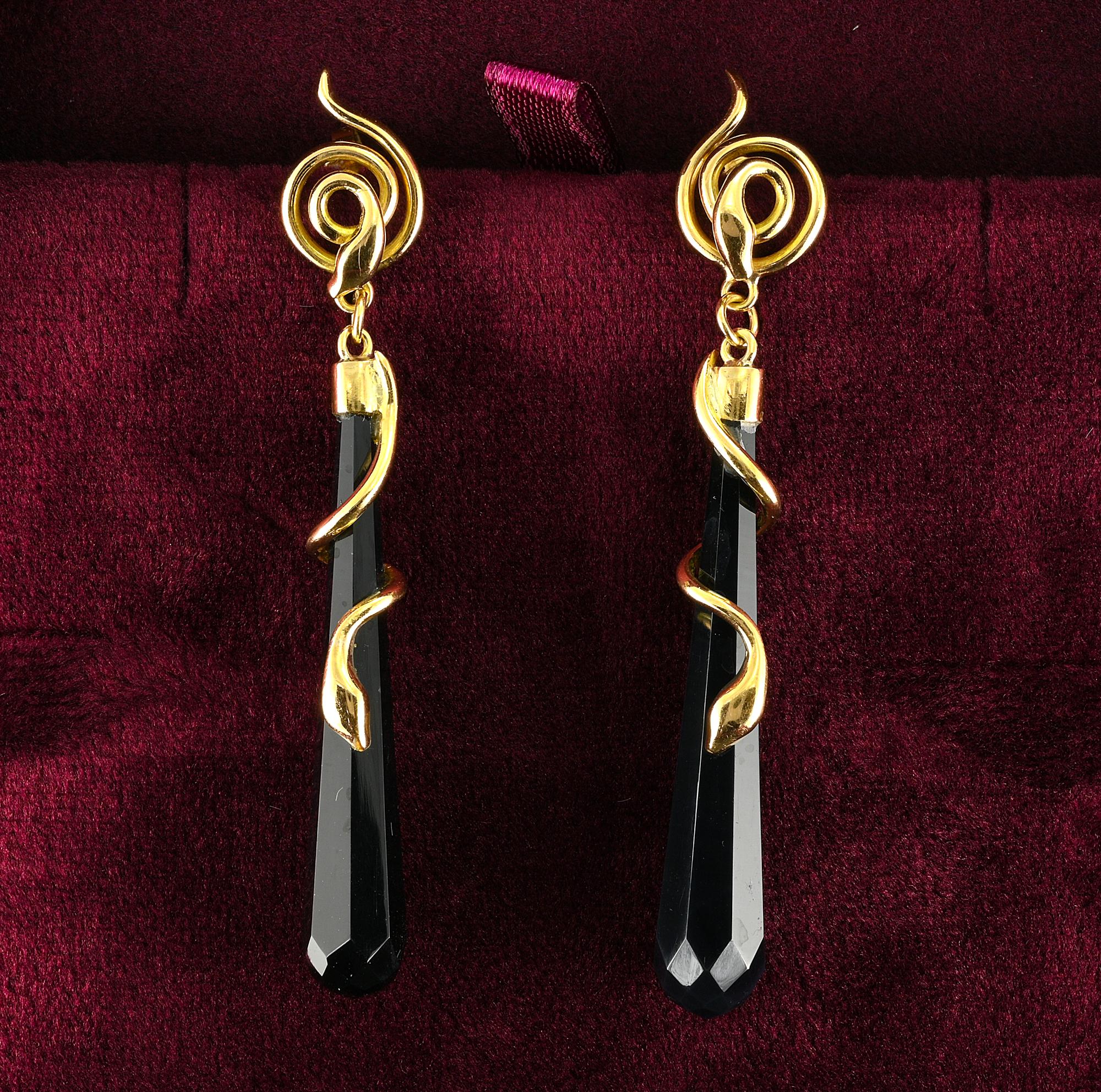 These beautiful long torpedo earrings are Art Deco period, 1925 ca
Hand crafted of solid 18 KT gold with a fascinating snake motif coiling around a long drop of Black Onyx multifaceted torpedo shaped, top is a snake coiling in round
Italian
