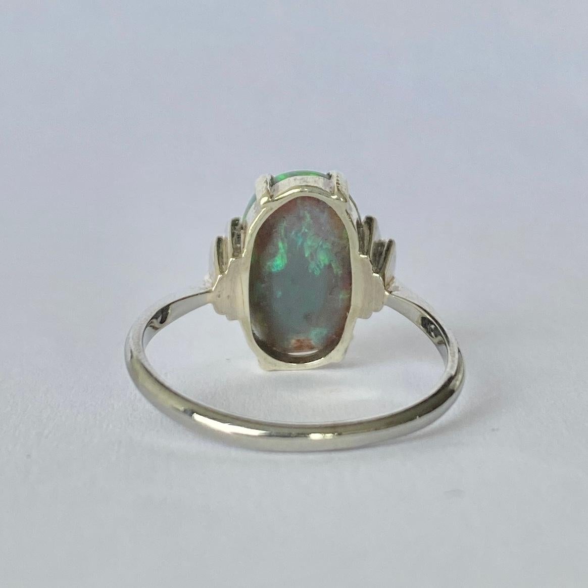 The colour of this 3 1/2carat black opal is exquisite! It is set between classic step shoulders. The rest of the ring is modelled in 18ct white gold. 

Ring Size: N /2 or 7
Stone Dimensions: 13x9mm
Height Off Finger: 5mm

Weight: 3g