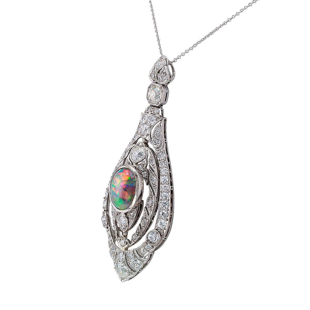 Art Deco black opal diamond platinum and white gold pendant circa 1925.
DETAILS:
DIAMONDS: sixty-four circular old-cut diamonds totaling approximately 2.75 carats, approximately H – K color, VS – SI clarity.
GEMSTONES: one oval-shaped black opal