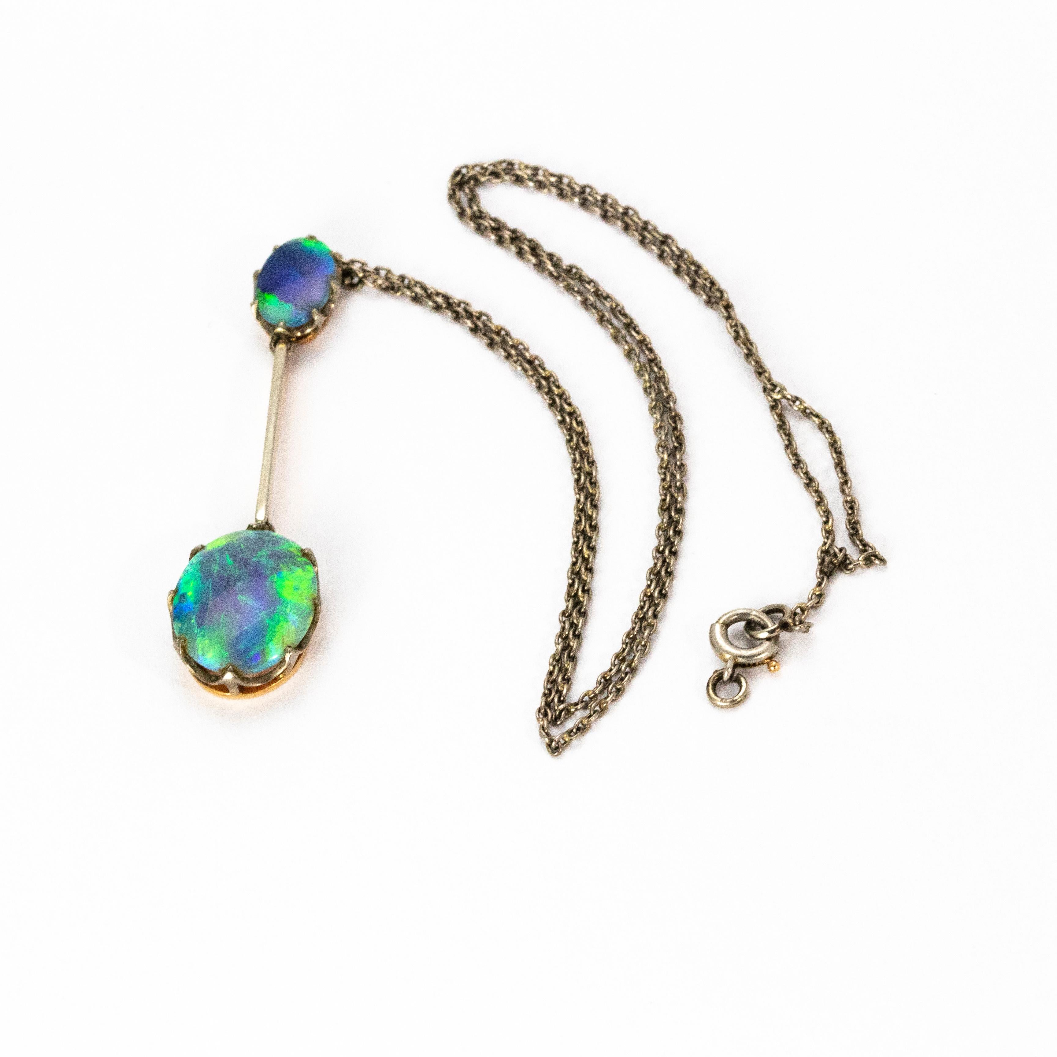 A simply stunning Art Deco pendant necklace. The pendant boasts two black opals which effervesce with colour. The smaller opal measures 2 carats, and the larger drop opal measures an impressive 9 carats. The wonderful stones are set in platinum and