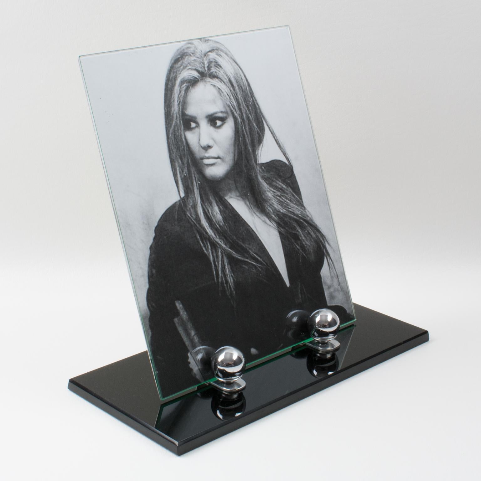 This lovely French Art Deco picture photo frame features a thick black opaline glass plinth complimented with two polished chromed metal holders and two chromed bead accents. The photograph is enclosed by an aluminum sheet at the back and a glass