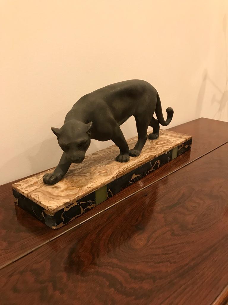 Art Deco signed Meland White metal panther statue in black finish, mounted to Portoro marble base. One corner of the marble has chipped off please see pictures.