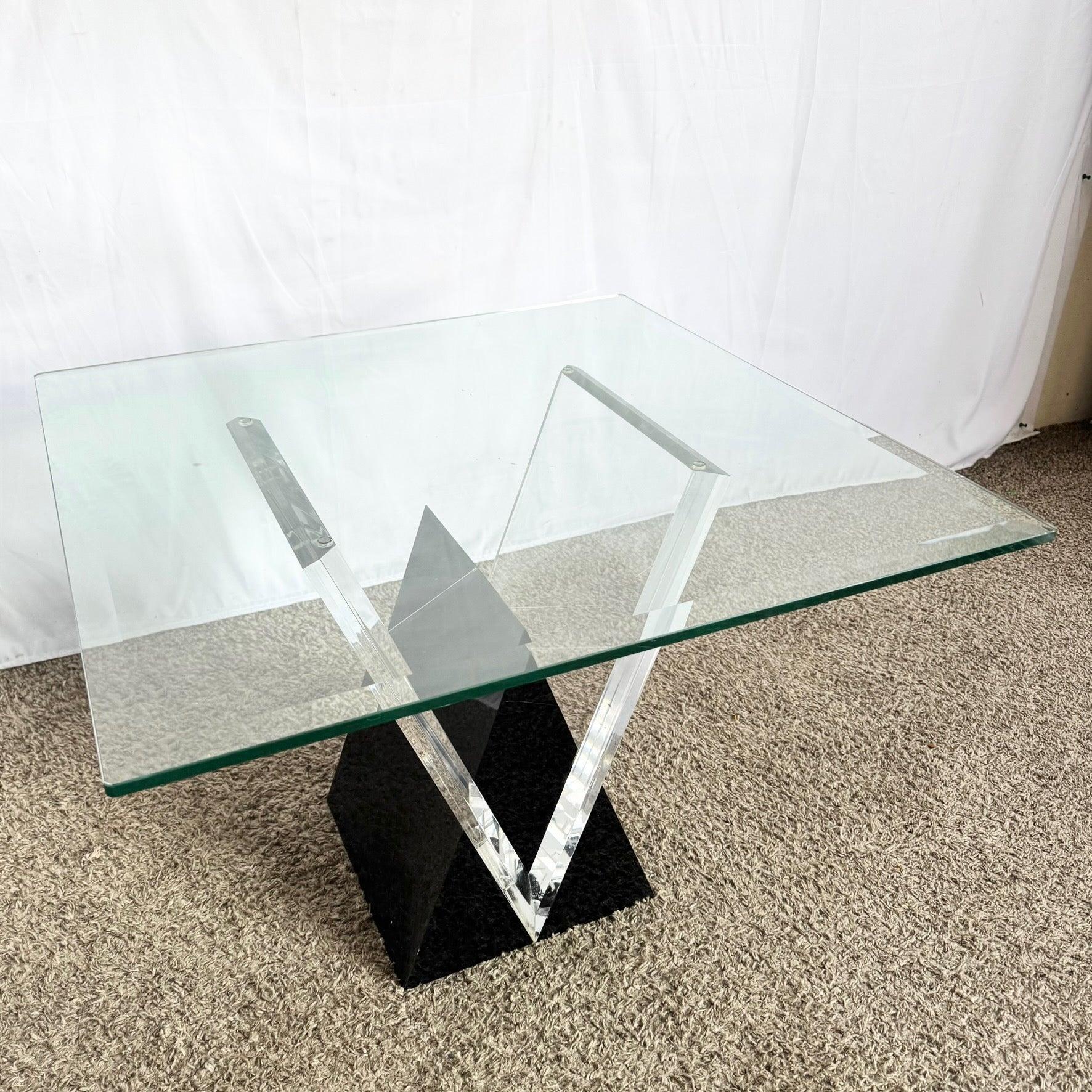 Postmodern Black Lucite Glass Side Table—sharply sculpted black Lucite base with glass top, offering bold Art Deco elegance and sculptural flair.
 

 We sell items as acquired, without restoring or repairing. Vintage pieces may have age-related