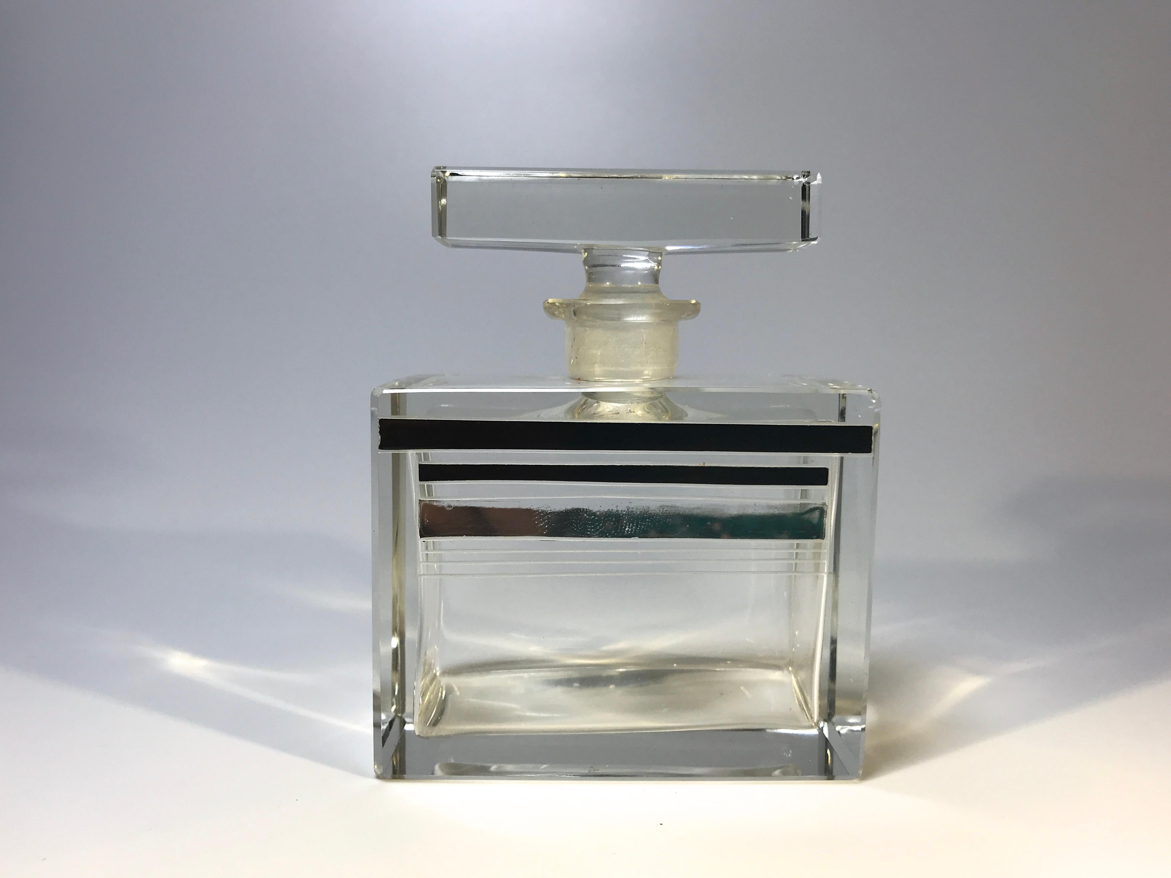 Art Deco hand blown Czech crystal perfume bottle from the 1930s
Very likely by Karl Palda
Classically shaped, with geometric lines of black and silver enamel
Vintage Bohemian, Czech crystal,
circa 1930s
Measures: Height 3.5 inch, width 2.75 inch,