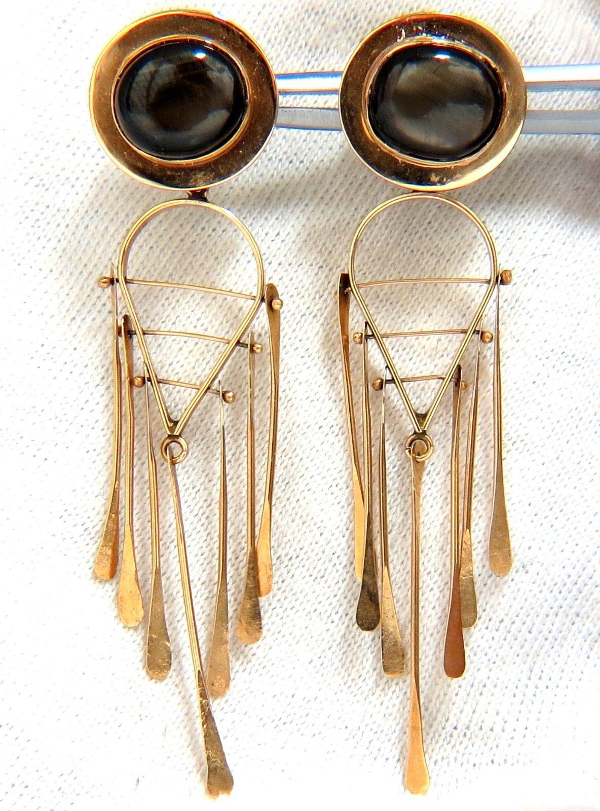 Art Deco Style Dangle / Dream Catcher

6.00ct black star cabochons

Clean Clarity & Transparent

8 X 10mm each

Secure push backs

Excellent detail.

14kt. yellow gold

10 grams.

.63 inch wide upper

2.50 inch long total