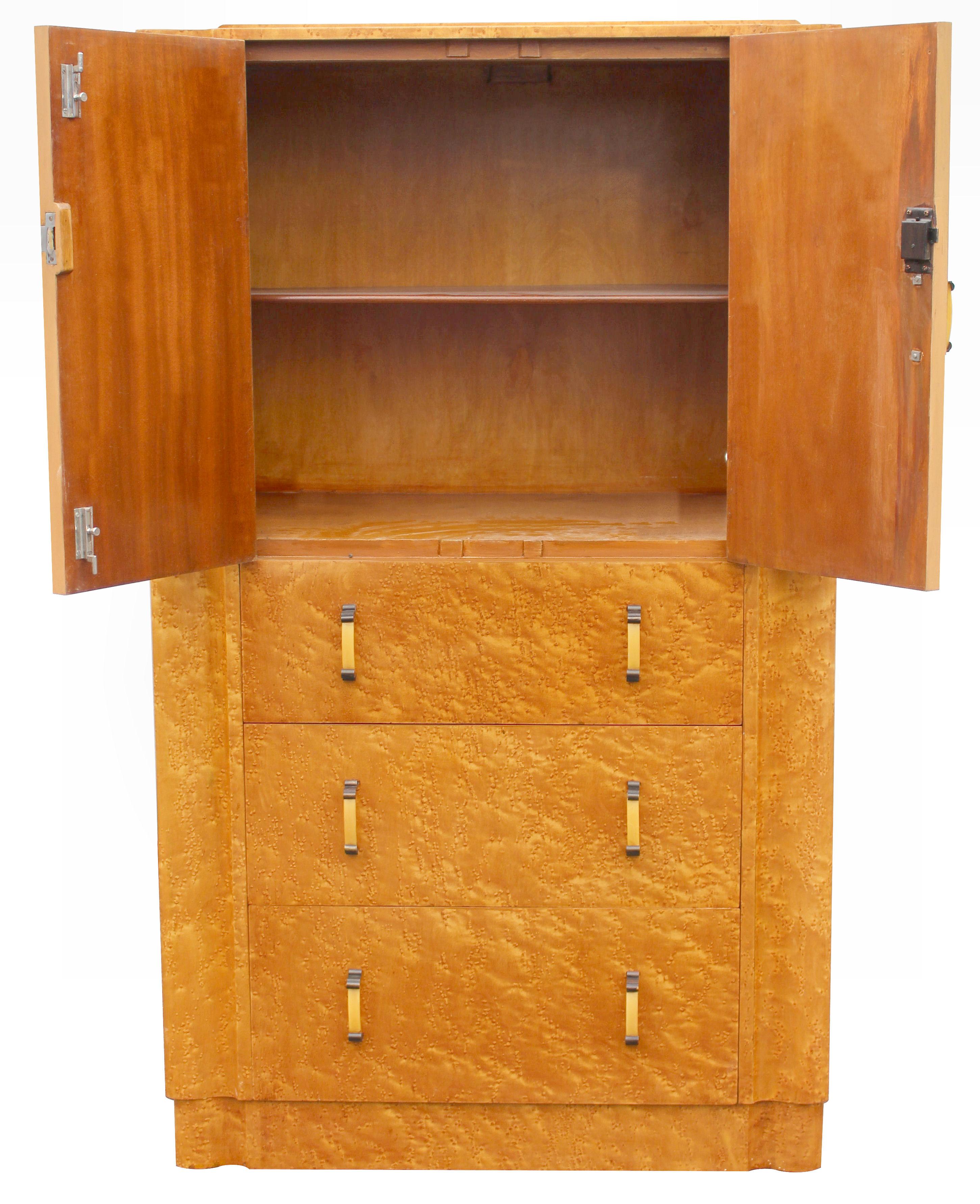 For your consideration is this English Art Deco blonde birds eye maple two-door, three drawer single-piece tallboy, circa 1930 and in excellent original condition. Not only does this tallboy look the part but it's extremely useful too having a very